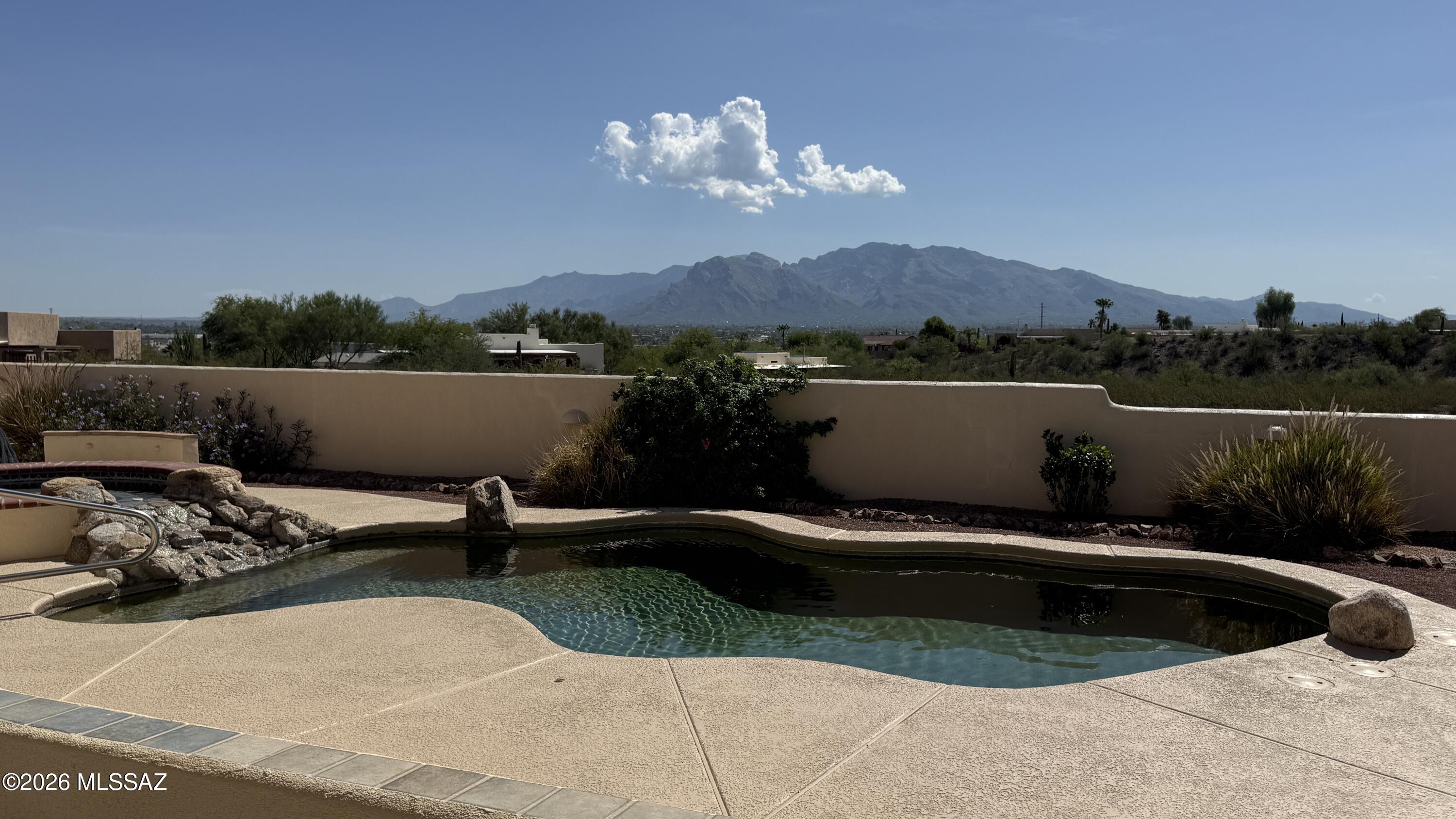 Professional photos coming soon. Nestled on a sprawling 1.07-acre lot in sought-after Silverbell Hills Estates, this custom-built single-story 3-bedroom plus den home has been well cared for. Panoramic Catalina Mountain and city views stretch across the horizon. Open flowing spaces give everyone room to breathe, with a den perfect for a home office. Wide hallways and a roll-in shower make everyday living effortless. The oversized 3-car garage handles vehicles, storage, and projects with ease. Enjoy a pebble tec pool and spa with freshly recoated deck and epoxied patio. The expansive lot offers room to build an RV garage or casita -- HOA amenable with approved plans. Marana Unified schools.