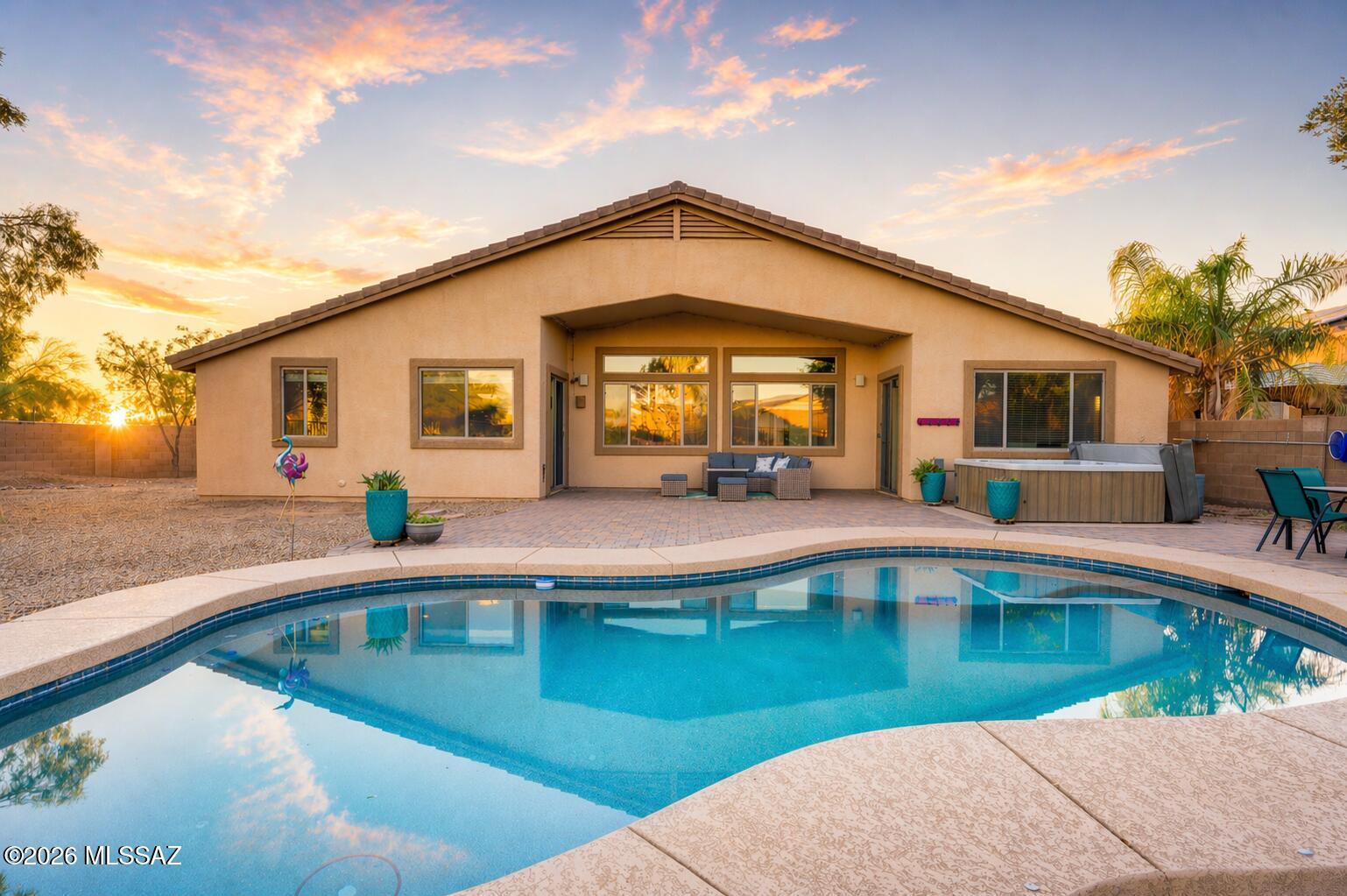 Range Pricing: Seller to counter or accept offers between $499,900 and $524,900. Tucked away on a cul-de-sac cove and set on a massive lot, this beautifully cared-for home offers the kind of backyard and location that rarely come along. Backing to Stonegate Park with a view fence, you can enjoy open space, mountain views, and no direct rear neighbors while still being close to everything Gladden Farms has to offer. The backyard was designed for both relaxing and entertaining, featuring a sparkling self-cleaning Pebble Tec pool, separate hot tub, and over 1,100 square feet of newer pavers that create an incredible outdoor living space. Whether you're soaking in the sunset over the mountains or hosting friends, this backyard is ready to impress. Inside, you'll find extended tile flooring throughout the main living areas, a striking 54-inch electric fireplace that creates a beautiful focal point, and thoughtful updates that make everyday living easier. The water heater and water softener were both replaced approximately two years ago, and the home is equipped with an EV charger for added convenience. The location is just as special as the home itself. Enjoy easy access to neighborhood trails and paths, The Loop, soccer fields, baseball fields, dog parks, the splash pad, and the new Marana Aquatic & Recreation Center. This is the perfect opportunity to enjoy space, views, recreation, and all the best of the community in one exceptional property. Homes with this kind of lot, park views, pool, and location do not come along often. Come see why 12462 N Stone Ring Drive might just be the one you have been waiting for--schedule your private showing today before someone else calls it home.