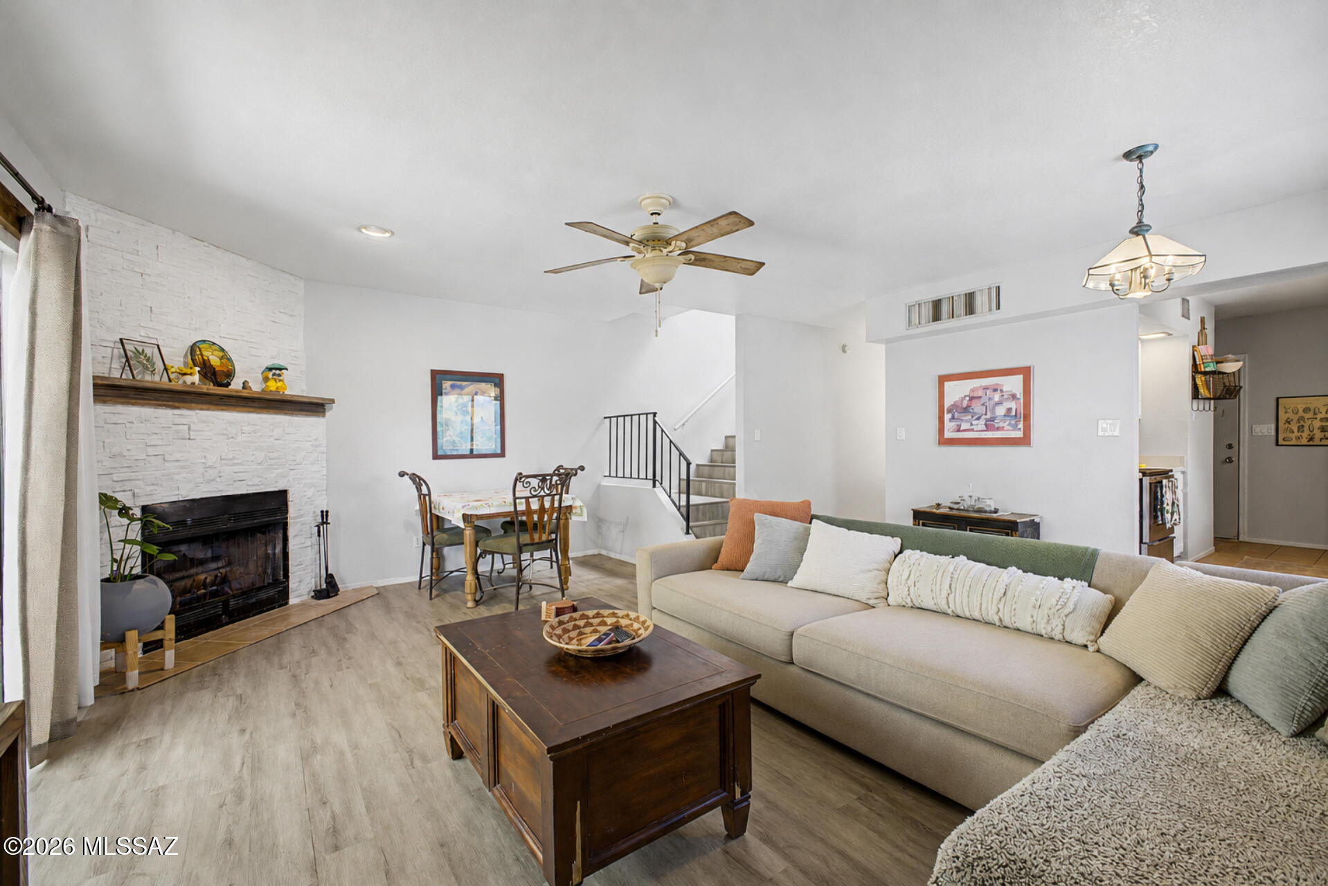 Privately situated at the end of a quiet cul-de-sac in the Las Lomitas community, this end-unit townhome offers added privacy, mountain views, and Tucson sunsets. The 2-bedroom, 1.5-bath floor plan features 1,269 sq ft of living space with a spacious great room, wood-burning fireplace, skylight, and multiple outdoor areas. The primary bedroom includes a private covered balcony with outdoor storage, while the second bedroom opens to a large terrace. Additional features include an enclosed yard, attached 2-car carport, washer and dryer, and access to the community pool, spa, and guest parking. Conveniently located near shopping, dining, downtown Tucson, and Oro Valley.
