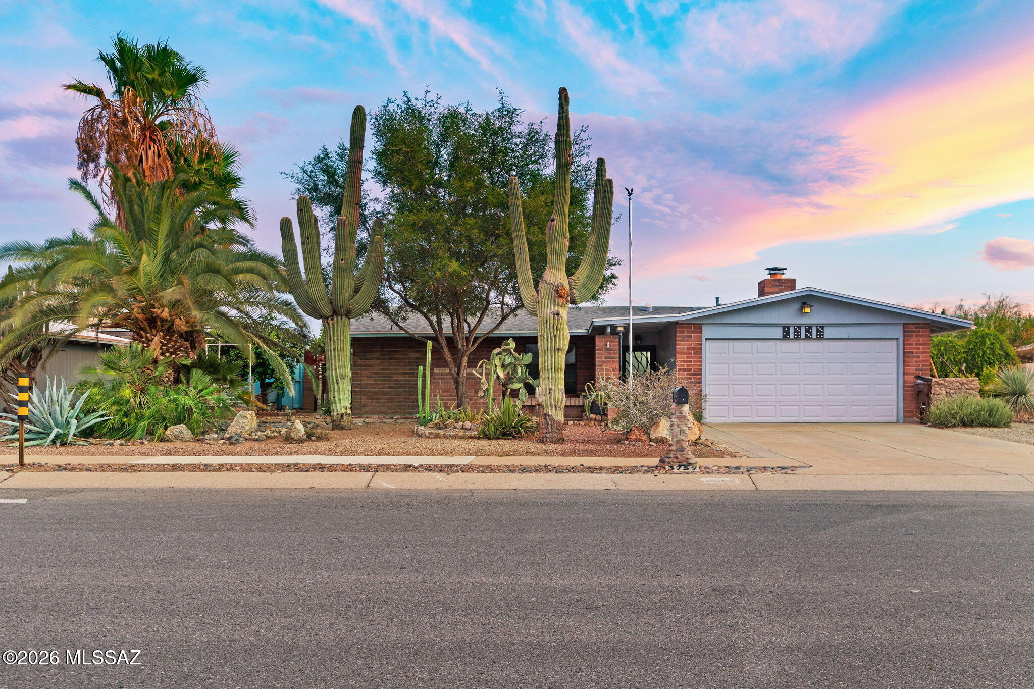 Location, lifestyle, and space come together in this beautifully updated NW Tucson home! Situated on a generous lot just minutes from everything you could need-including Topgolf, Costco, Home Depot, shopping, restaurants, & countless everyday conveniences. This 3-bed, 2-bath home offers the perfect blend of comfort & functionality. The heart of the home is the beautifully updated kitchen featuring Silestone countertops, stone backsplash, SS appliances, & solar tubes that provide natural light throughout. The kitchen opens seamlessly to the inviting great room where a striking beehive gas fireplace creates a warm focal point, while French doors lead to an expansive AZ room w/ a beautiful wood-paneled ceiling. The spacious primary suite offers a peaceful retreat w/ walk-in closet, and large tile shower. Step outside and discover your own backyard oasis. Enjoy Arizona summers in the sparkling pebble-tec pool and entertain or unwind in the additional spacious yard featuring covered sitting area, fruit trees, real grass, a small greenhouse for gardening enthusiasts, and multiple storage sheds and plenty of room for hobbies, pets, or outdoor activities.