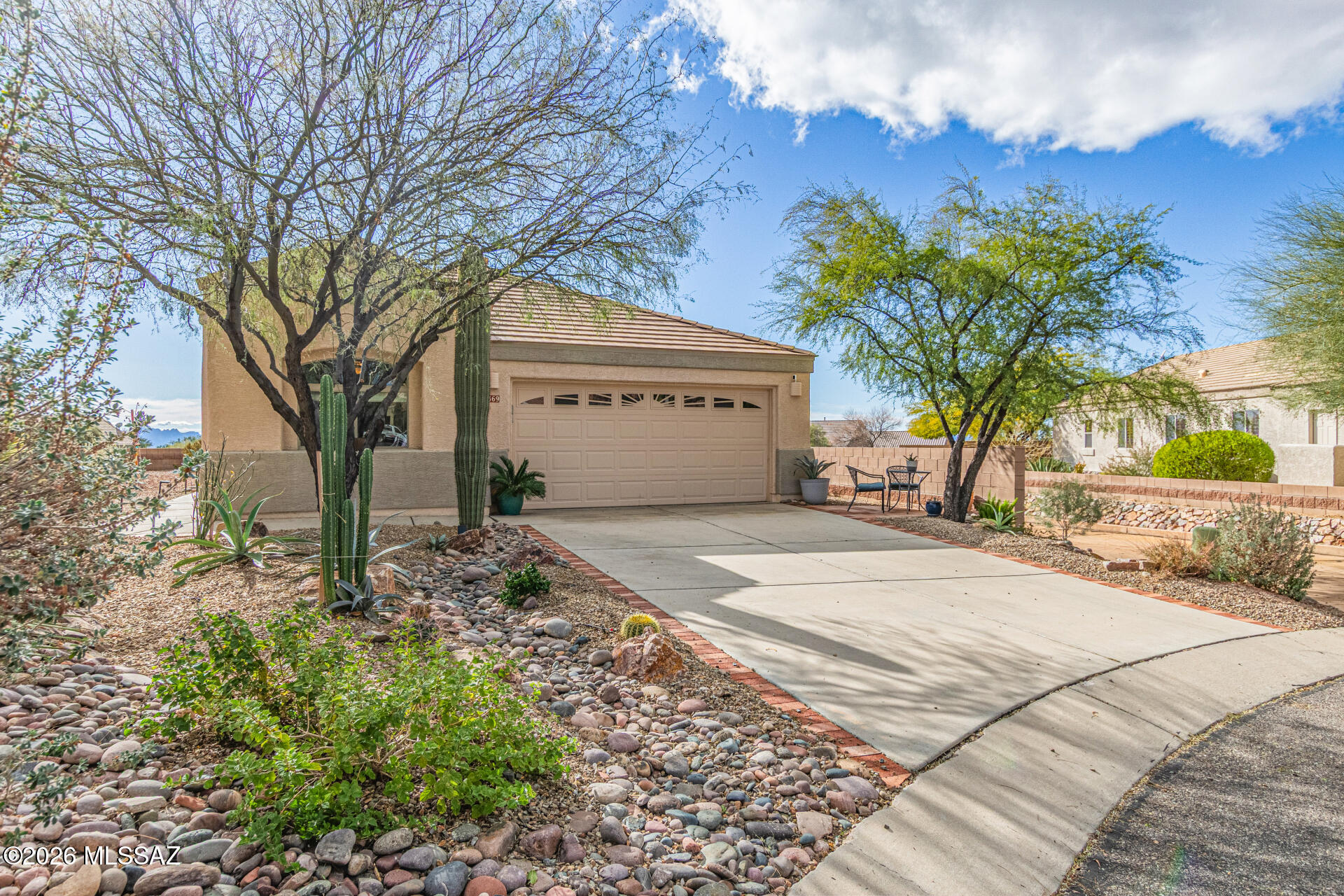 3 bedroom home nestled on a quiet cul-de-sac with mountain views. Fully fenced backyard is a private retreat featuring multiple entertaining areas, custom fire pit with built-in seating, flagstone patios, and desert landscaping. Two citrus trees complete this outdoor paradise. Open concept floor plan with spacious kitchen w/ large pantry closet, oversized island, and great room flooded with natural light. The primary suite features vaulted ceilings and mountain vistas. 2 additional bedrooms offer flexibility for guests or office space. Recent upgrades include new HVAC system, newer appliances, custom garage flooring and energy-efficient ceiling fans throughout. Move-in ready and designed for both entertaining and peaceful relaxation. Convenient to The Ritz Carlton Dove Mountain and premier hiking/biking trails. This premiere active adult community offers resort-style living with 24-hour manned security, golf, tennis, pickleball, fitness center, pool, hot tub, restaurant/bar, and numerous clubs and social activities. Stay active all day or relax in your private oasis!