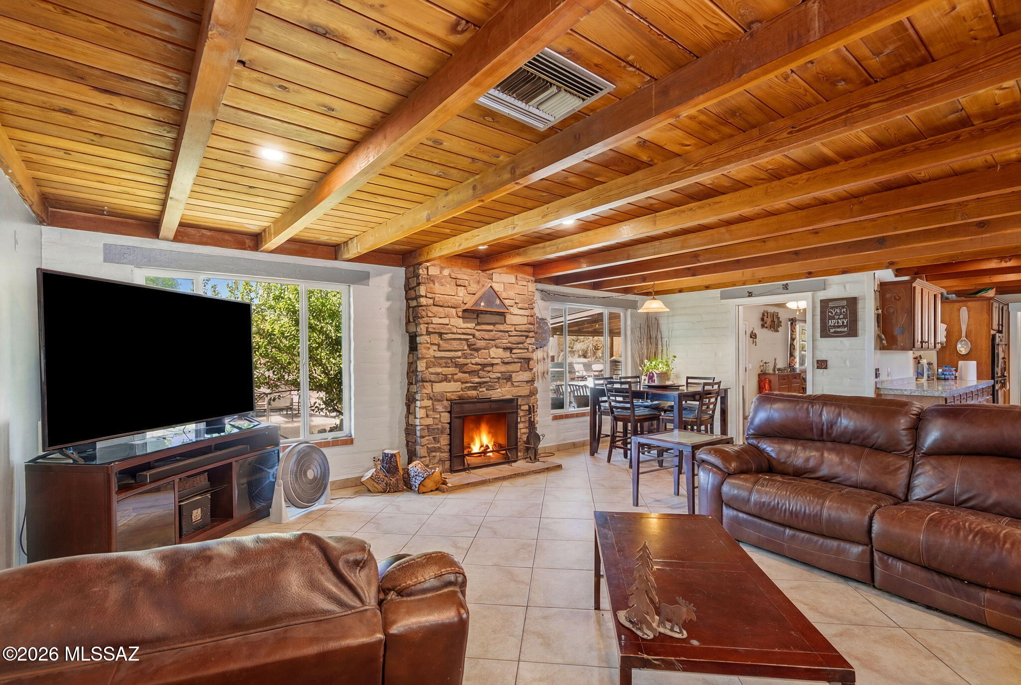 Beautifully remodeled horse property on 1.34 acres offering the perfect blend of luxury, space, and Arizona outdoor living. This 3,752 sq ft home features 4 bedrooms, 3 bathrooms, an open great room with exposed wood beam ceilings and stacked-stone fireplace, plus an incredible 1,100 sq ft bonus room ideal for entertaining, game nights, a home theater, or multi-purpose living. Step outside to your private backyard retreat with a sparkling pool, covered patio, sunken outdoor grilling station with TV hookup, and mountain views. Complete horse facilities include 2 stalls, turnout, tack room, and feed room--bringing country living just minutes from city conveniences.