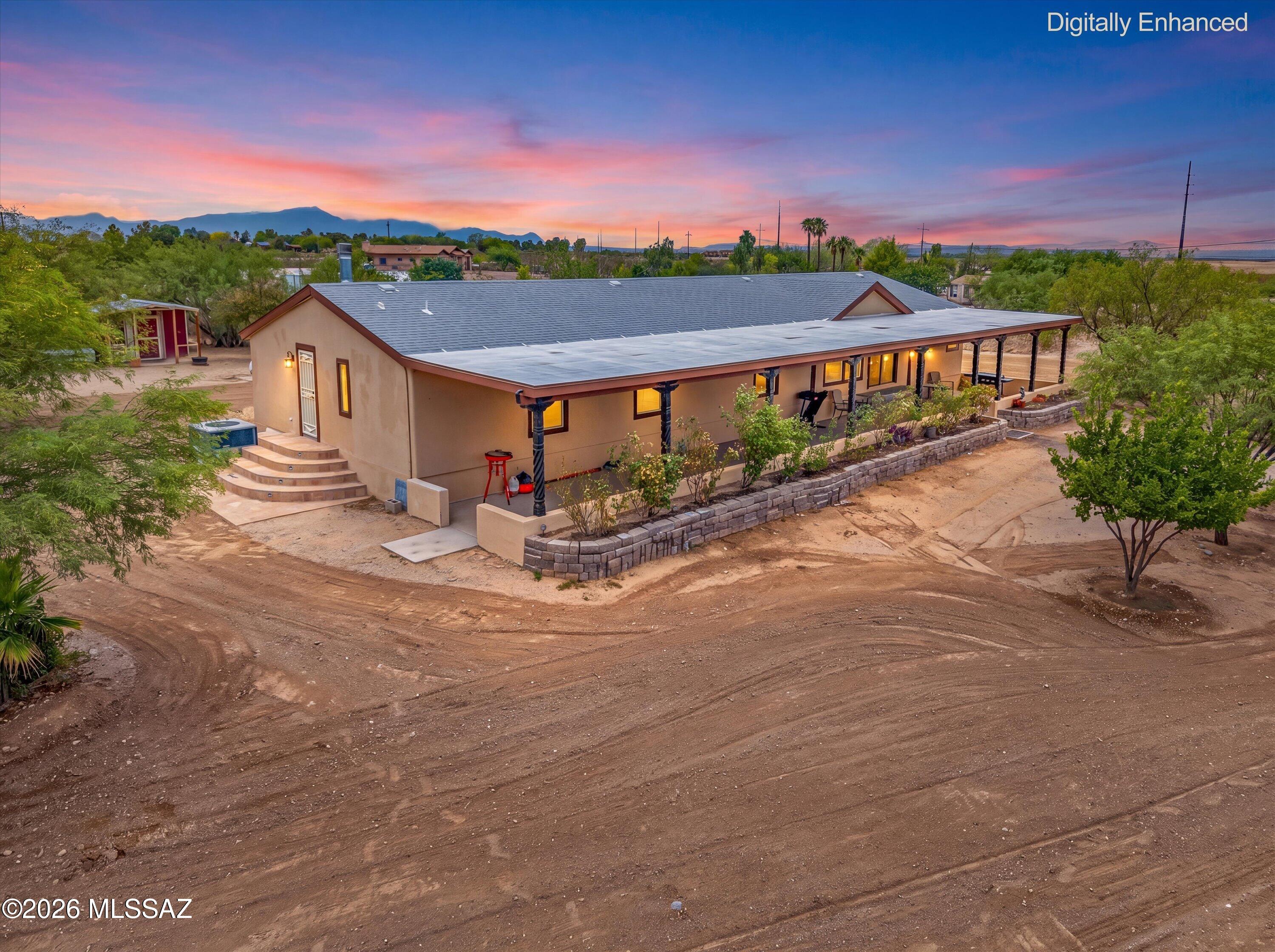 Escape to the peace and privacy of country living on 4.25 beautiful acres. This well-maintained 2,240-square-foot home offers 4 spacious bedrooms, 2 full bathrooms, and a versatile den within a thoughtfully designed split-bedroom floor plan that provides both comfort and privacy.

Designed for everyday living and entertaining, this home features both a formal living room a separate family room + bonus room, offering flexible spaces for gatherings or quiet evenings at home. The custom kitchen is the heart of the home, with custom alder wood cabinetry and island offering ample workspace for meal prep and hosting guests

Step outside and discover your own private desert oasis. Beautifully landscaped with mature fruit trees, colorful rose bushes, and and multitude of trees, saguaro and ocotillo, the grounds create a peaceful retreat you'll love coming home to. Imagine starting your mornings  or winding down in the evening with your favorite beverage on the covered patio as you take in breathtaking Arizona sunrises, vibrant sunsets, and the quiet beauty of the surrounding desert. The expansive 4.25-acre parcel offers endless possibilities for horses, recreational vehicles, gardening, or simply embracing the freedom of wide-open space.

Additional highlights include a private well for reliable water service, a solar system to help reduce energy costs, a 1-car garage/workshop, a 1-car carport with storage, a bird coop, and plenty of room to expand or customize to fit your lifestyle.

If you've been searching for space, privacy, and the freedom that comes with acreage, this exceptional property is one you won't want to miss.