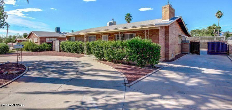 Exceptional investment and multi-generational living opportunity! This unique property offers 2 homes for the price of one with no HOA, just 2 miles north of the U of A. The main home features 3 bedrooms, 2 baths, a cozy fireplace, bonus AZ room off the kitchen, tile flooring throughout, scored concrete in the bedrooms, ceiling fans in every room, and a spacious kitchen with an island, tile backsplash, and included appliances. The recently remodeled guest house has its own private entrance, courtyard, backyard, laundry room, custom cabinetry, oversized tile shower, walk-in closet, large-format tile flooring, and fireplace. Both homes have newer HVAC systems (main 2018, guest 2019). Live in one and rent the other, lease both for income, or enjoy the flexibility for extended family.
