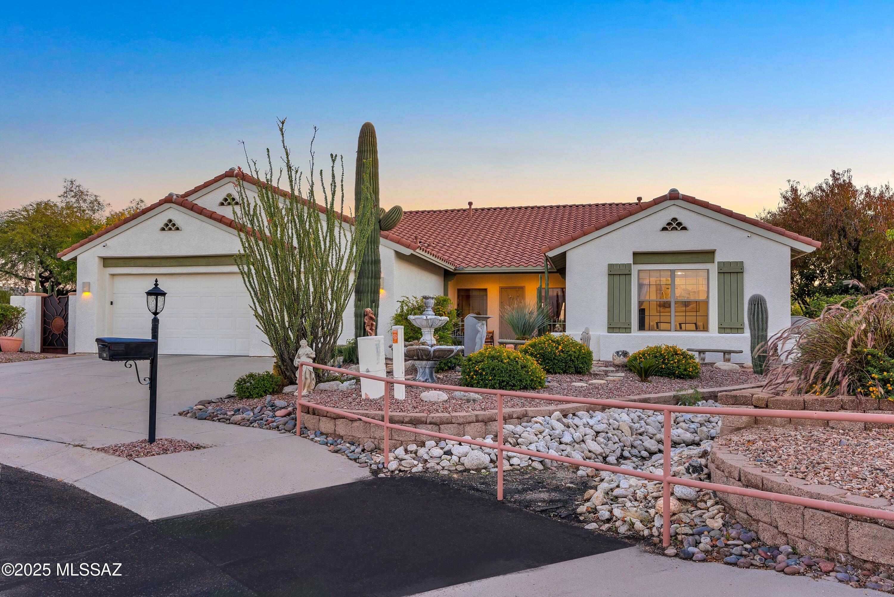 Experience desert luxury at its finest in this beautifully updated residence at 1798 S Sunlit Sand. Set on an exquisitely landscaped homesite, the property showcases more than a dozen thriving fruit trees, lush native plantings, and winding flagstone pathways that lead directly into nearly 50 acres of HOA-owned open space—creating a serene, private retreat with unobstructed views of all four iconic Tucson mountain ranges. Inside, the thoughtful split-bedroom layout highlights a renovated primary bathroom, expansive windows and updated sliding doors that frame stunning vistas, and a modern kitchen equipped with newer stainless steel appliances (2021). The home offers peace of mind with a new roof (2022), new water heater (2023), and numerous upgrades throughout. Step outdoors (continued) to enjoy a heated saltwater pool and spa, generous patio areas perfect for entertaining, and a spacious three-car garage. This exceptional property blends tranquility, comfort, and refined desert living in every detail.