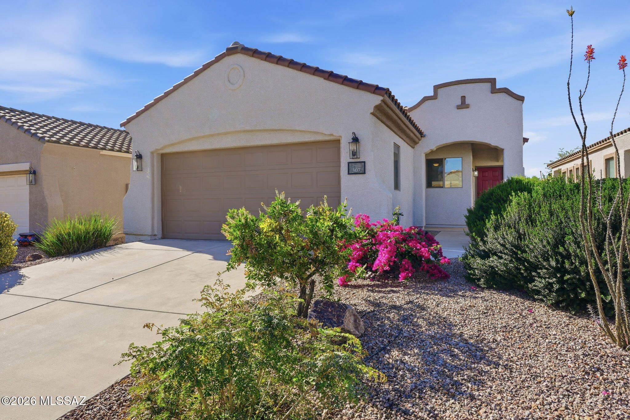 Experience refined desert living in this beautifully maintained single level home in the desirable  55 plus community of Sonora at Rancho Sahuarita. A spacious great room welcomes you with abundant natural light and effortless flow into the kitchen featuring lots of crisp white cabinetry, pantry closet, a cozy kitchen nook and breakfast bar.  The split bedroom layout offers comfort and privacy, and the serene primary suite includes a generous walk-in closet, elegant finishes & walk-in shower. Step outside to a south facing backyard filled with lush colorful landscaping and a large, covered patio ideal for relaxing or entertaining. Make this home your home today.
