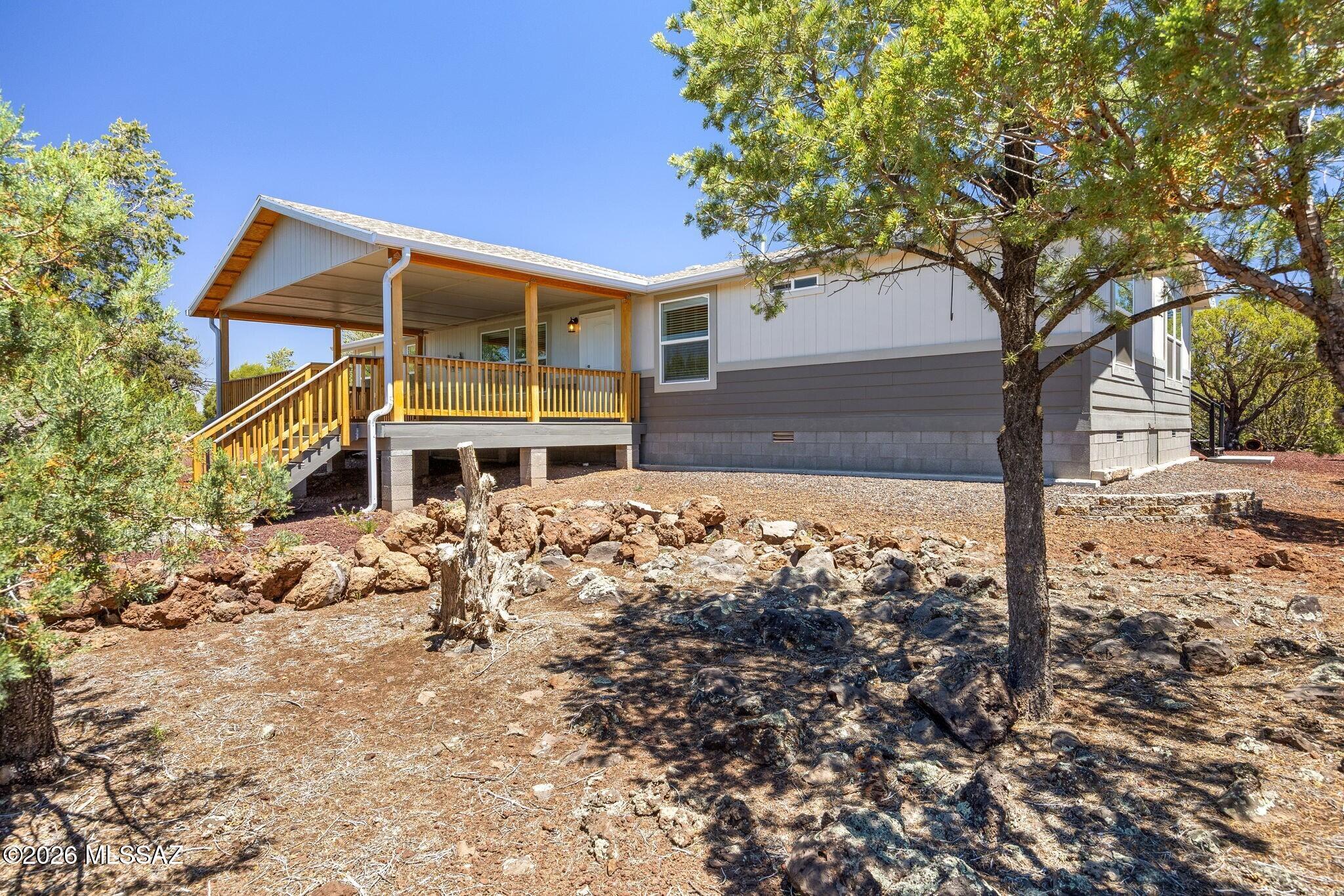 Set on over 2 picturesque acres with stunning mountain views & sweeping views of Ortega Draw, this beautifully maintained property offers the perfect blend of comfort, space & charm. Designed with both functionality & style in mind, the home features 3 beds, 2 baths, plus separate living & family/bonus rooms for flexible living or entertaining. The impressive kitchen is the heart of the home with a massive 9' x 4½' island, SS appliances, Corian counters, gas range, walk-in pantry & upgraded staggered cabinetry w/crown molding. Quality upgrades throughout include 2x6 construction, vaulted ceilings, modern lighting, ceiling fans, plush carpet & wood plank vinyl flooring. Step outside to enjoy Arizona living at its best from the oversized covered 25' x 16' Trex front deck or the 24' x 12' Trex backyard deck perfectly positioned to capture the incredible views. The property is fully equipped for hobbies, storage & outdoor living with his & her sheds/workshops, greenhouse, RV parking with water, septic access & both 30 & 50 amp hookups. A truly special move-in ready property offering privacy, views & room to enjoy it all!