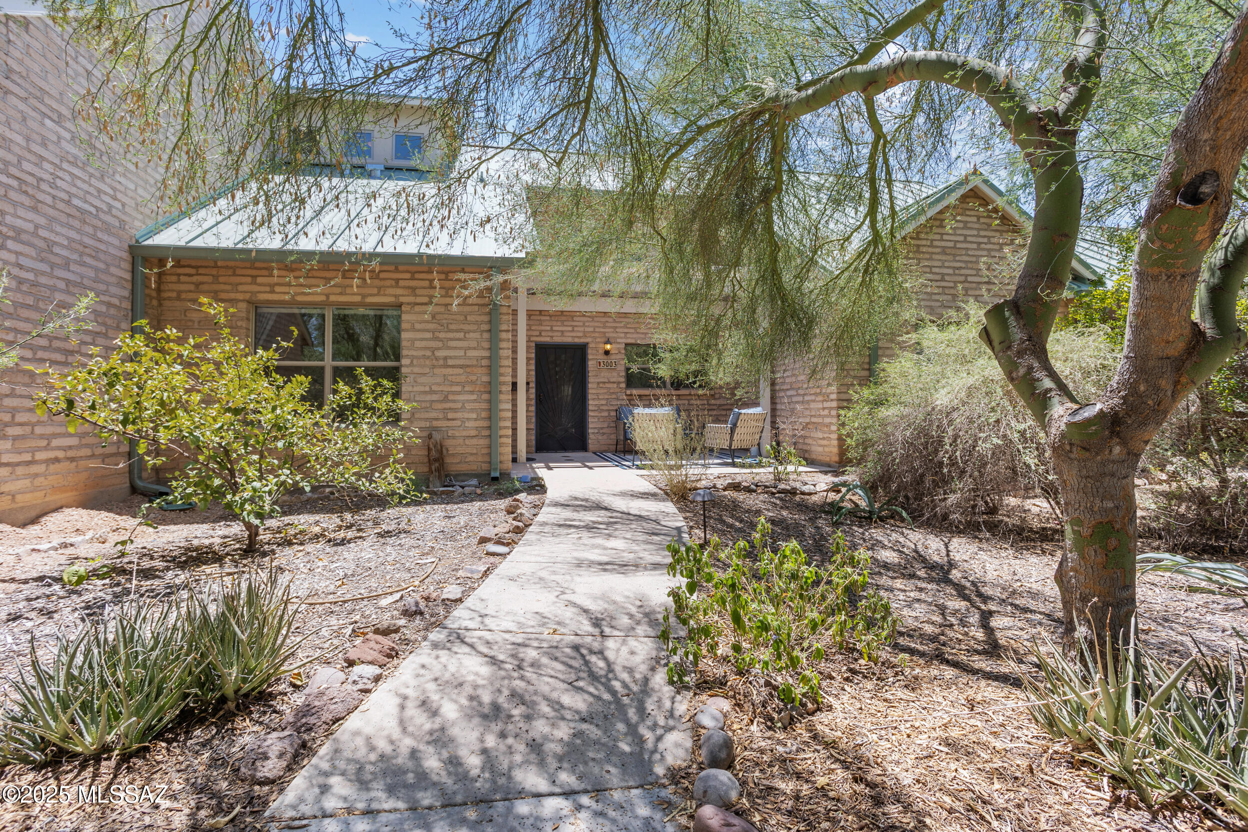 Welcome to Milagro - An Award-Winning Cohousing Community in the Desert!
Located on a 43-acre site with 35 acres preserved as natural desert, Milagro is one of Tucson's most unique and environmentally sustainable communities. With just 28 'green built' homes crafted from high-end, locally sourced materials, Milagro offers a rare blend of modern comfort, eco-conscious living, and strong community connection. (Learn more at MilagroCohousing.org.)
Home Features: This thoughtfully designed home includes two bedrooms and two bathrooms on the main level, plus a stackable washer and dryer for convenience. The open kitchen flows into the living and dining areas, enhanced by soaring vaulted ceilings that fill the space with natural light.