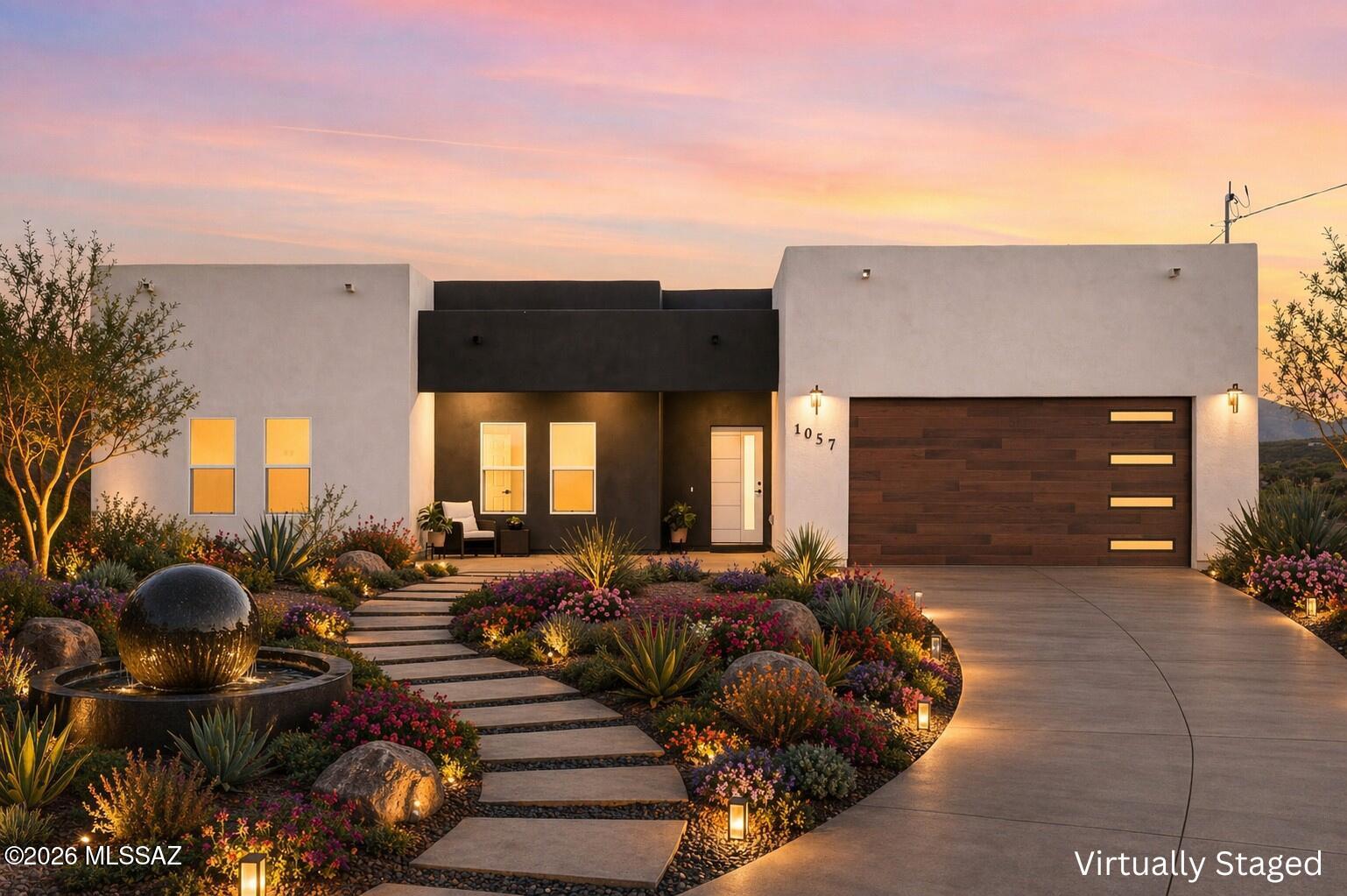 Experience modern Southwest living in this stunning new construction home nestled on 1.91 acres in the rolling hills of Rio Rico. This thoughtfully designed 3BD, 2BTH residence offers 1,611 sq ft of contemporary style, luxury finishes, and breathtaking mountain and sunset views. Inside, you'll find 9-foot ceilings, abundant natural light, and an open-concept layout centered around a spacious kitchen featuring quartz countertops, stainless steel appliances, ample cabinetry, & a large island perfect for entertaining. The spa-inspired bathrooms showcase floor-to-ceiling porcelain tile and designer finishes throughout. Set well away from neighboring homes, this private retreat offers peace, tranquility, & endless possibilities on nearly 2 acres, room for a pool, guest house, & more.