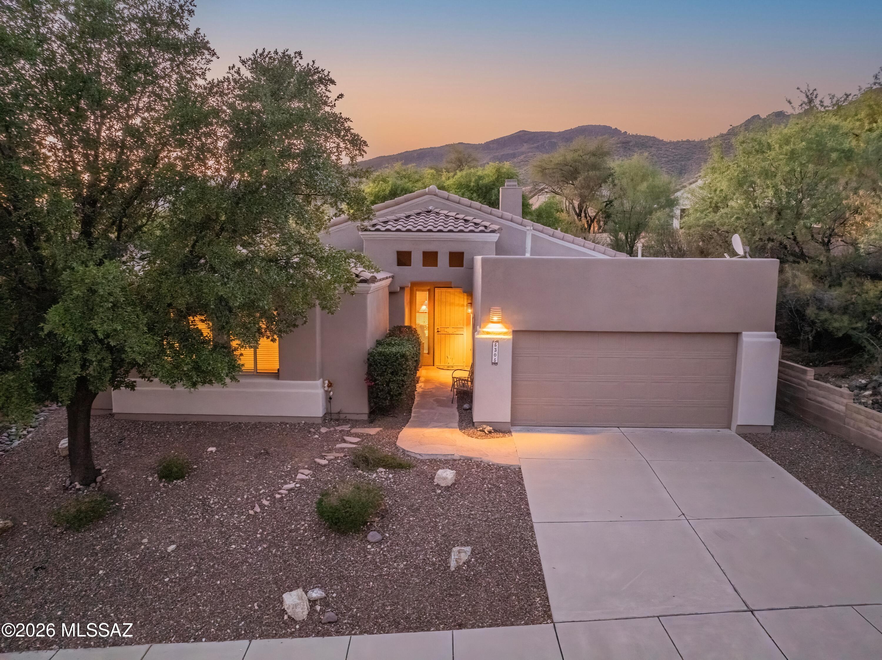 Welcome to this meticulously maintained contemporary home in the prestigious, guard-gated golf community of Sabino Springs. Perfectly positioned in Tucson's desirable northeast side, this beautifully updated residence is just a short walk to the community pool, fitness center, and Arizona National Golf Club, offering an exceptional blend of luxury, comfort, and convenience.
Built in 2000, this 2,036-square-foot home features an inviting open-concept, split-bedroom floor plan with three spacious bedrooms, two full bathrooms, and a versatile den/office ideal for working from home or creating a private retreat. Soaring ceilings, abundant natural light, updated flooring throughout, Hunter Douglas window coverings, and a built-in Sonos sound system with in-ceiling speakers in the kitchen and and dining room create a warm, sophisticated living environment.
The beautifully remodeled kitchen, is the heart of the home and showcases quartz countertops, a designer tile backsplash, a breakfast bar with seating, and LG stainless steel appliances. The spacious great room flows seamlessly to the outdoor living spaces, making entertaining effortless.
The luxurious primary suite offers a spa-inspired bathroom remodeled with quartz countertops, updated flooring, modern lighting and mirrors, and a beautifully redesigned tub and shower. Additional interior updates include a custom tiled fireplace , professionally painted ceilings, freshly painted great room and dining room ceilings (2026), and newly painted kitchen, dining room, and laundry room (2026).
Step outside to enjoy professionally landscaped grounds featuring flagstone at both the front entry and backyard patio, an inviting outdoor BBQ area, an irrigation system, and dark exterior sun screens for enhanced energy efficiency. The property has been consistently cared for with professional landscaping every five weeks and regular pest control service.
This home offers exceptional peace of mind with an impressive list of major improvements, including a complete roof replacement with new tile (2017), water heater replacement (2019), HVAC replacement (2020) with a transferable Rite Way maintenance agreement through May 2027, Culligan/Water Tec water softener (2020), garage flat roof replacement by Cervantes Roofing (October 2025) with a transferable 3-year warranty, exterior repainting (January 2026), outdoor water shut-off installation (2024/2025), annual garage door maintenance by A1 Garage Door Service, and meticulous annual preventative maintenance throughout. The washer and dryer, including a washer that is approximately one year old, are also included with the sale.
This move-in-ready home combines timeless style, thoughtful updates, and outstanding maintenance in one of Tucson's most sought-after golf communities. Don't miss this opportunity to enjoy resort-style living in beautiful Sabino Springs.