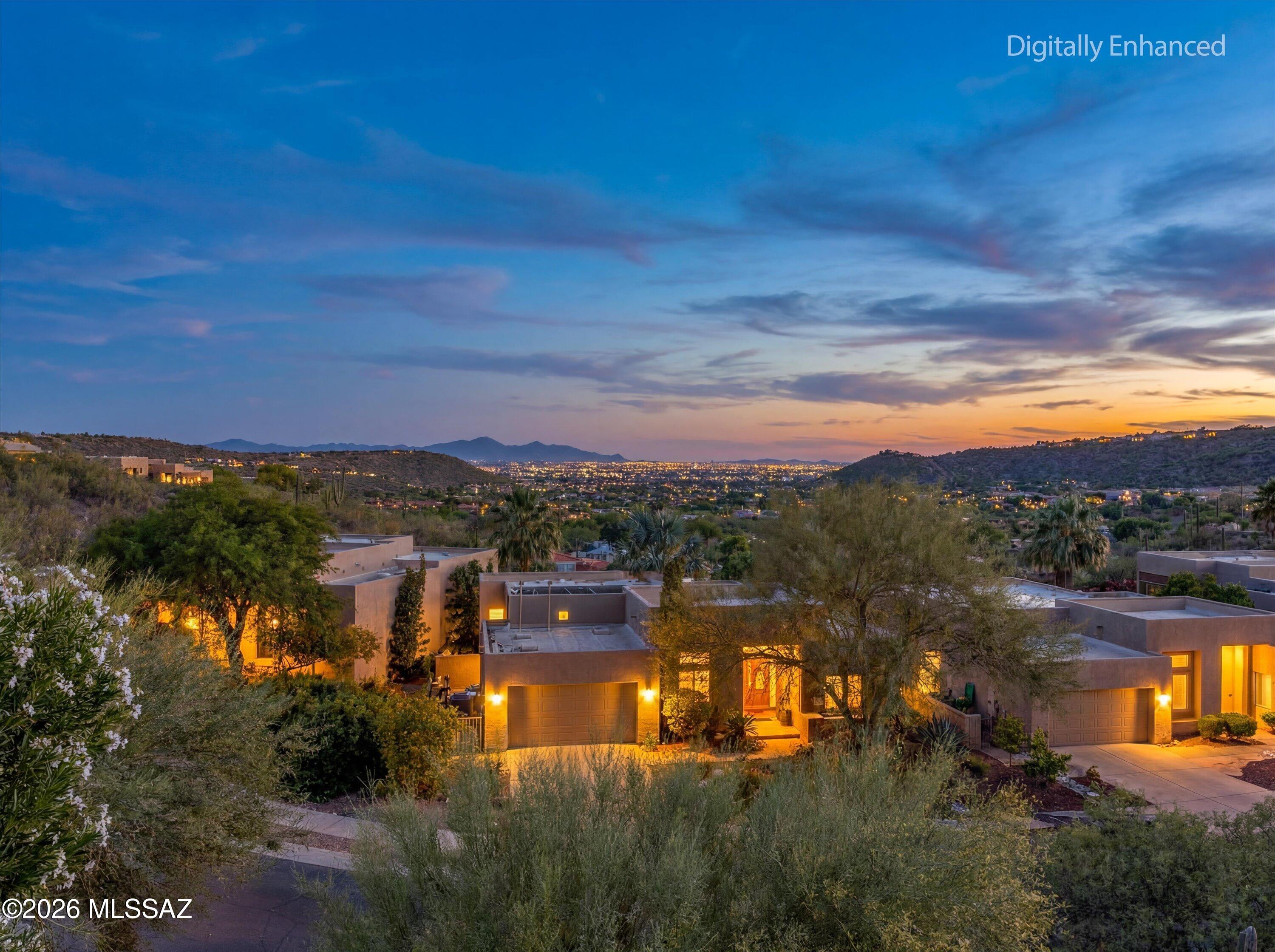 Stunning Foothills Retreat with Panoramic City & Mountain Views nestled within the gated enclave of Bonita Ridge. This
 beautifully maintained 4-bedroom, 3-bath residence offers a rare blend of privacy, elegance, and breathtaking desert scenery. Perched to capture sweeping city and mountain views, the home showcases unforgettable sunsets and sparkling city lights from its serene backyard oasis.
The light-filled interior features expansive windows that flood the home with natural light, creating a warm and inviting ambiance throughout. The tastefully updated kitchen features generous cabinetry, ample counter space, a dedicated prep area, and a breakfast bar--perfect for both everyday living and entertaining. A main-level guest bedroom and full bath provide ideal flexibility for visitors o multigenerational living. Upstairs, the spacious owner's suite is a true retreat, complete with a private balcony overlooking the valley below. Two additional bedrooms complete the upper level, including one with a Jack-and-Jill bath and another with its own private balcony. Located just minutes from trailheads, shopping, restaurants, and the natural beauty of Sabino Canyon Recreation Area. This home offers the perfect balance of convenience and tranquility.  Enjoy community luxuries including landscaped paths, a large pool, spa, and secure gated entrance. Welcome Home!
