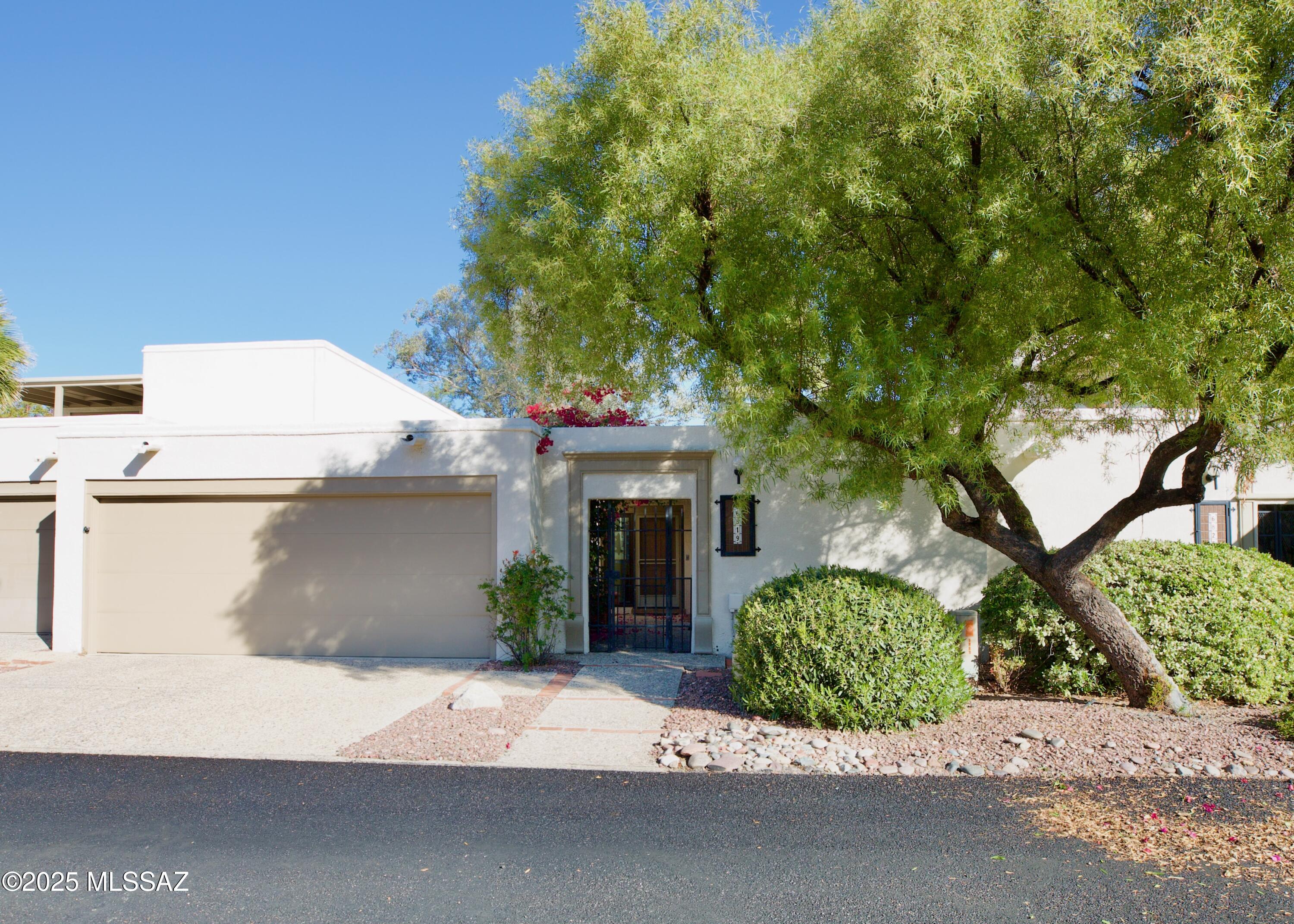 Updated 3BR 2 Bath Dorado Country Club townhome offering comfortable single-level living in a convenient Tucson location. A gated front courtyard welcomes you into a bright interior that connects easily to the outdoor patio spaces. High ceilings in Formal Dining Rm and Living Rm with stone gas fireplace, clerestory windows, and wet bar. Updated Kitchen and Bathrooms with Granite counters and modern cabinets. Wood-look tile in living areas, carpet in bedrooms. North-south exposure with mountain views and no homes behind. Skylights & ceiling fans throughout. Eat-in Kitchen with ample cabinets. Nearby laundry room and extra storage. Spacious 2-car garage. Enjoy access to community amenities and close proximity to shopping, dining, and services.Refrigerator, Washer/Dryer Included