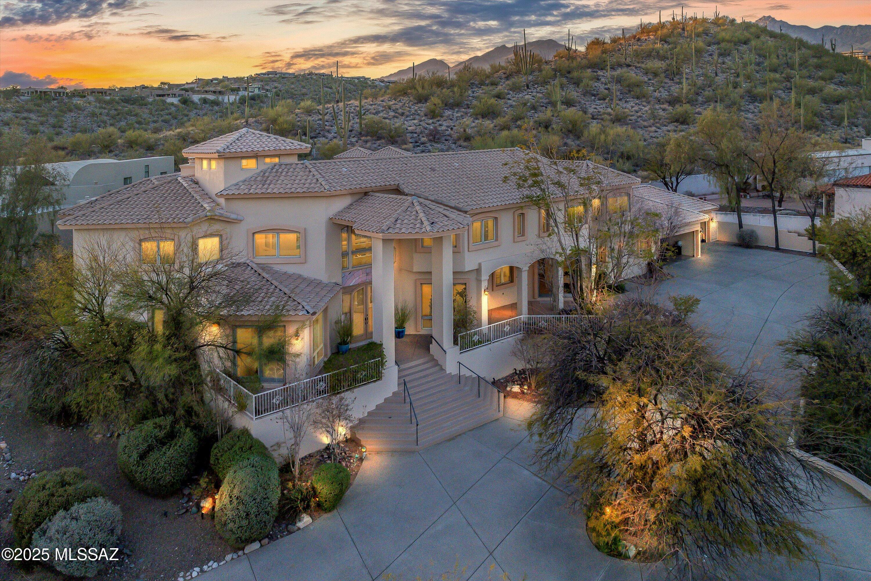 On top of the hill, in prestigious Sabino Vista Hills community, this breathtaking Mediterranean-style estate, designed by renowned architect John Campisano, offers an unparalleled blend of elegance, comfort and views. Built with masonry stucco construction and custom large windows, this residence spans 7,492 square feet hosting a remodeled six bedrooms, 5 full bathrooms and a powder room, on a beautifully landscaped 0.97-acre lot. Upon entry, guests are greeted by a grand foyer with soaring ceilings and looking out to the backyard oasis. Stained concrete, wood and tile flooring throughout leading into a formal living room with one of three fireplaces with mountain and city views. Owner/Agent