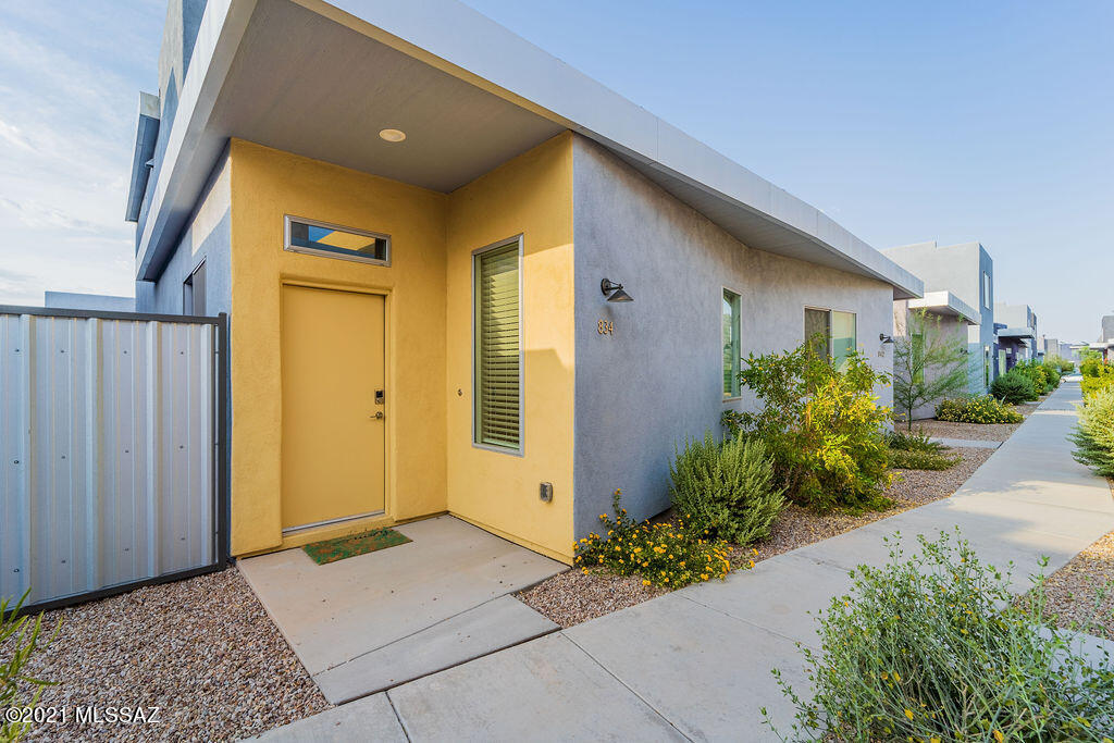 Like new, modern 2 bedroom and 2.5 bathroom home centrally located near popular restaurants, shopping, and the University of Arizona.  First floor has an open floor plan with a powder room and a spacious kitchen, great for entertaining! Second floor has 2 bedrooms with private bathrooms and a separate loft area with skylights that is perfect for a study room or home office space. Low maintenance side yard with front yard landscaping managed by HOA. This house is super clean and move in ready!  Excellent home for college students or a small family! There is also a side yard. All appliances stay and furniture is also negotiable.