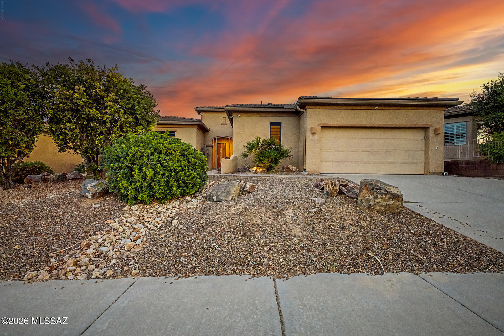 Arizona living with beautiful mountain views! Don't miss this highly upgraded, former model home with a new roof, 3-car garage (with AC) & private courtyard entrance. Designed with both function and comfort in mind, this home features upgraded appliances, granite countertops, glass-front cabinetry, tiled backsplash, under-cabinet lighting and abundant storage throughout. The den with double doors is tucked away and provides a flexible space for a home office or hobby room. The third bedroom is a private guest suite with its own entrance and ensuite bath, creating a comfortable retreat for guests. And don't miss all the features in the garage, it is a fully-finished workshop with central vac, air conditioning EV charging and built-in cabinets to maximize the space. The backyard is designed for enjoying Arizona living, featuring a pool, spa, built-in BBQ, north/south exposure, and mountain views. With no neighbors directly behind the property, you'll enjoy added privacy and open desert views that are difficult to find
