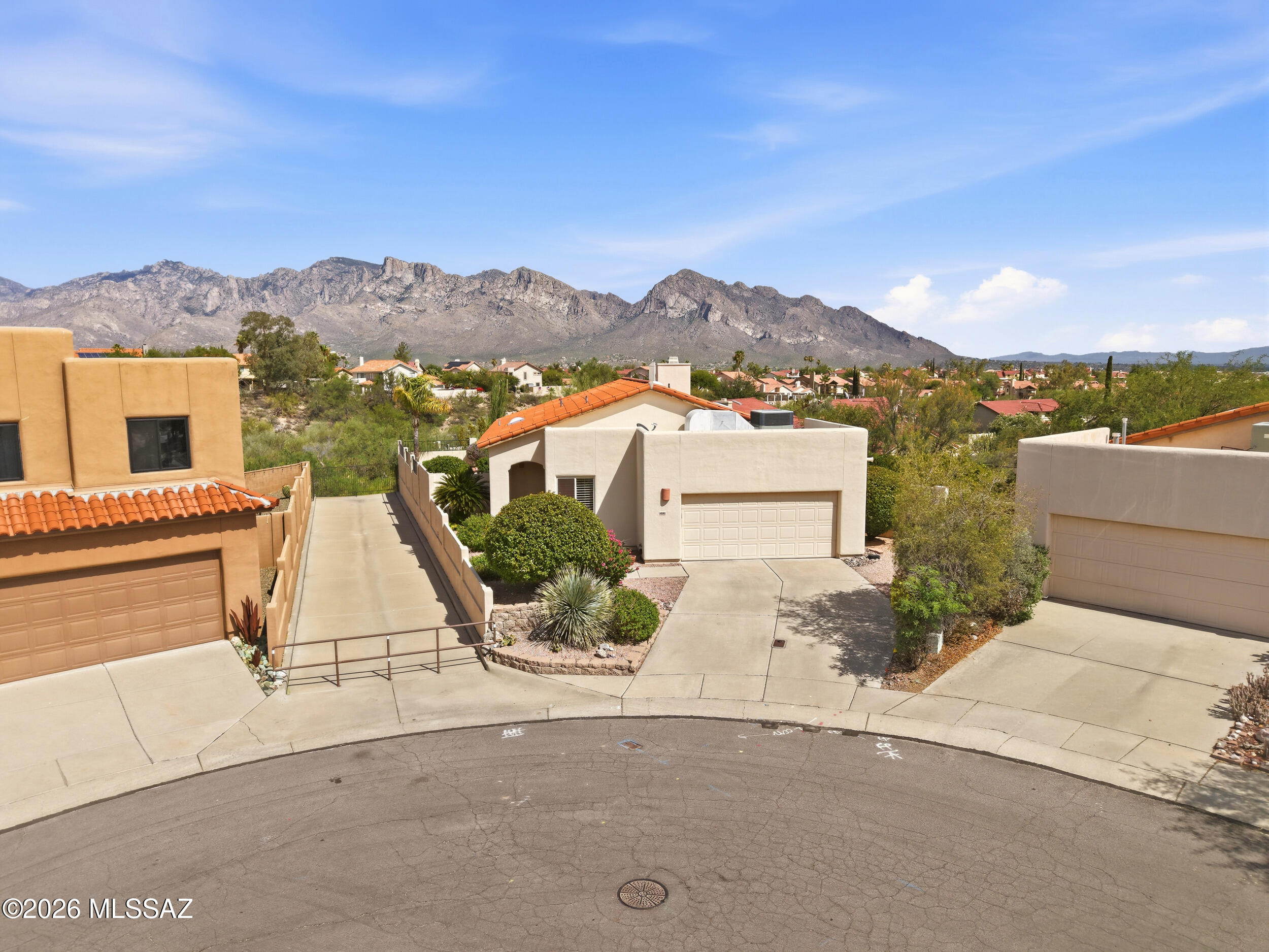 Tucked away on a quiet cul-de-sac in the sought-after Copper Creek community, this 3-bedroom, 2-bath home offers a rare blend of privacy, views, and potential. Backing to protected natural desert with generous space between neighbors, you'll enjoy breathtaking mountain views, colorful sunrises, and the peaceful sounds of the desert every day. Inside, the open floor plan is filled with natural light from multiple skylights and features tile flooring throughout, wood shutters, a beautifully renovated primary bath, newer dual-pane windows, two newer sliding glass doors, and a newer HVAC system. The major updates are already complete, leaving the interior ready for your personal touch. Outside, lush, manicured landscaping, mature citrus trees, an RV gate, and an expansive, uniquely shaped backyard create endless possibilities for entertaining or relaxing. With an irreplaceable setting in one of Oro Valley's most desirable neighborhoods, this home is ready for its next chapter.