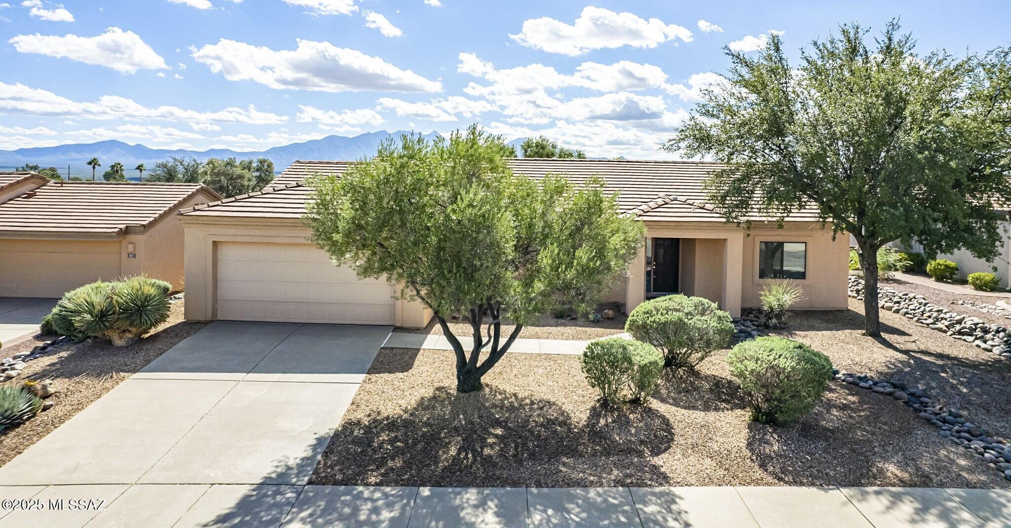 Experience the beauty of desert living in this inviting 2BD/2BA home with breathtaking mountain views in the highly desirable Ventura West neighborhood of Las Campanas! Step inside to find elegant luxury vinyl plank flooring throughout, where a spacious living room/dining area and an additional family room (separated by a stylish divider wall) share a soaring vaulted ceiling for an open and airy feel. The bright kitchen features a breakfast bar and cozy nook, ideal for morning coffee or casual meals. The owner's suite is a peaceful retreat with rear patio access, a generous walk-in closet, and an en suite bath featuring dual vanities and a walk-in shower. You'll appreciate the thoughtful details throughout, including a separate laundry room with utility sink and built-in cabinetry. The 2-stall garage has built-in storage cabinets and an 8'x8' bonus storage room. Outside, enjoy the serenity of low-maintenance desert landscaping enhanced by mature olive trees, ocotillo, and colorful native plants, all designed to showcase the wonderful mountain backdrop. With low HOA fees ($250/yr) and the GVR Las Campanas Center just a short walk away, this home combines comfort, convenience, and desert charm in one perfect package.