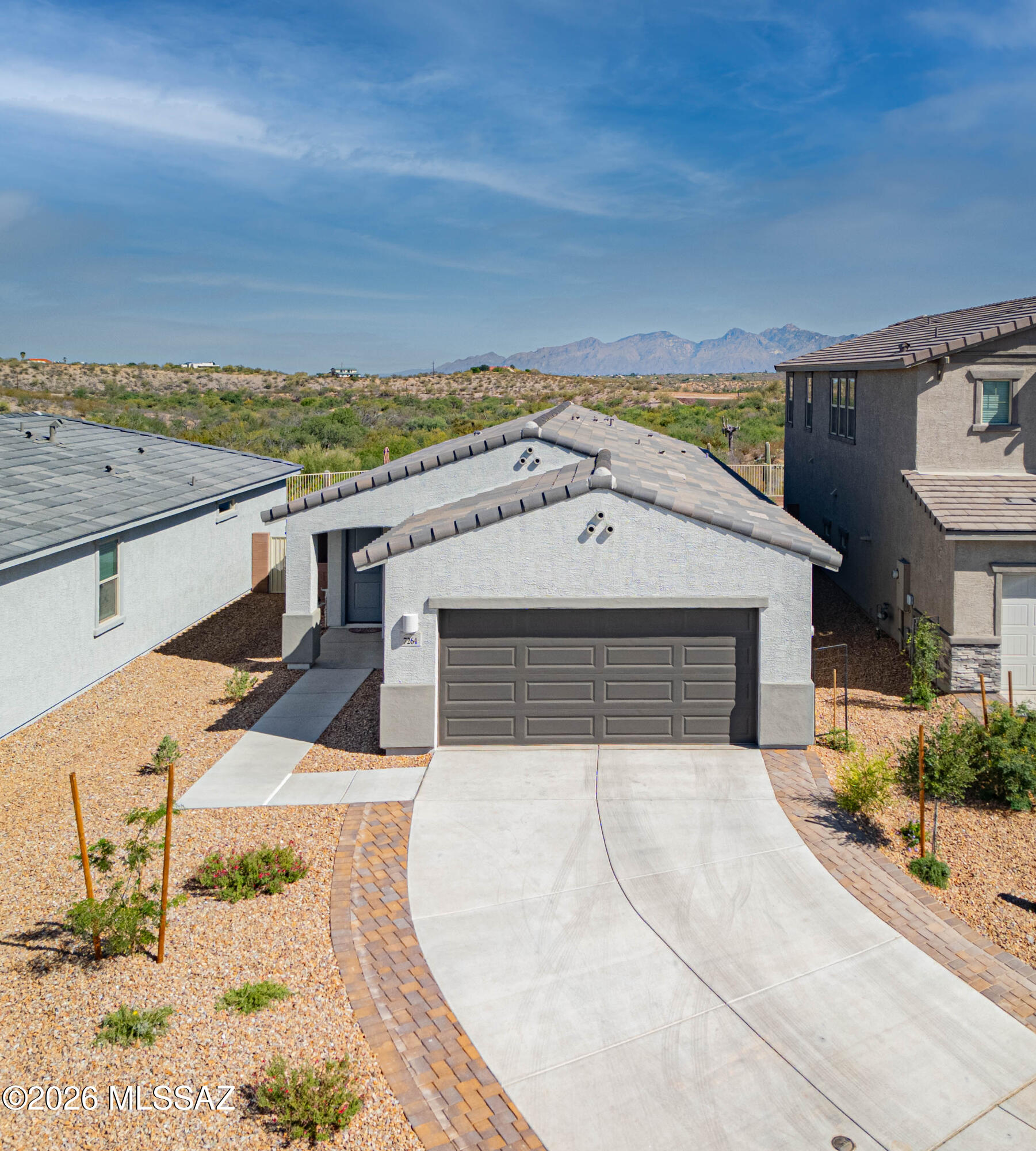Beautiful, ALMOST BRAND NEW 4 bedroom, single-story home at the end of a quiet cul-de-sac with STUNNING views of the Rincon and Santa Catalina Mountains, large backyard, and NO NEIGHBORS BEHIND!  An extended driveway brings you to your new home, with a wide open floor plan, high ceilings, ceiling fans in all four bedrooms and living space, and natural light throughout.  Lovely kitchen with white ''soft-close'' cabinets, brushed nickel hardware, large island, granite countertops, large pantry, and all stainless steel appliances under warranty.  Beautiful views from your dining and main living area.  Spacious primary suite with gorgeous desert and mountain views from the oversized window.  Primary bathroom with double vanity, private toilet, and large walk-in closet. Separate from the primary suite on the opposite side of the home, find three bedrooms, one full bathroom and two-car garage.  Your large backyard (with plenty of room for a pool!), has already been started for you with decorative gravel rock, but otherwise is a clean slate for your creative landscaping personal touches.  But don't forget about the popular Rocking K neighborhood, providing parks, playgrounds, pickleball, soccer, basketball, playscapes, and splash pad...and this fantastic home provides a well-maintained walking/biking path directly behind, giving you easy access to enjoy Tucson's outdoor desert beauty.  All builder warranties transfer to the new owners! All appliances stay, including refrigerator, washer, dryer!  Award-winning Vail School District!  Home is PRICED TO SELL!