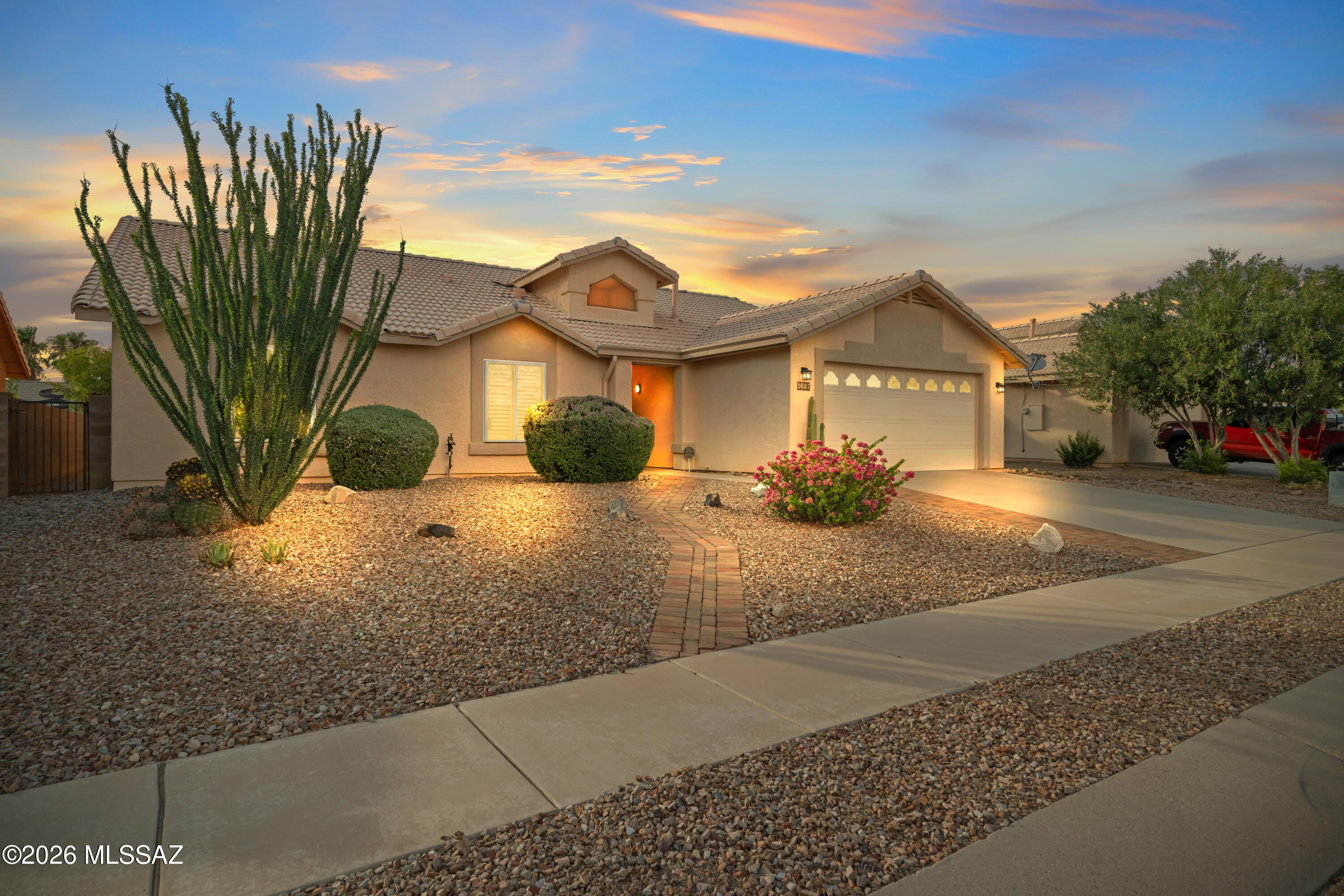 Beautifully maintained 4-bedroom, 2-bath home in the desirable Vail School District! This spacious single-story floor plan features soaring ceilings, abundant natural light, multiple living areas, and durable hard-surface flooring throughout. The open kitchen offers ample cabinetry, a breakfast bar, pantry, and flows seamlessly into the family room. The split primary suite includes a walk-in closet and custom-tiled walk-in shower. Enjoy Arizona outdoor living in the low-maintenance backyard with an extended covered patio, paver seating area, artificial turf, and mature fruit trees. Conveniently located near parks, shopping, dining, and top-rated schools, this move-in ready home is one you won't want to miss!
