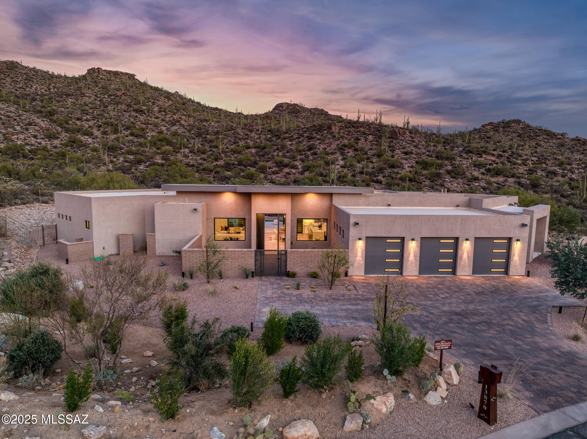 BRAND-NEW Luxury Custom Home. Secluded 1.62-acre homesite showcasing sweeping saguaro studded mountain vistas. Experience the pinnacle of modern desert living in the guard-gated community of Canyon Pass at Dove Mountain. Designed for the discerning luxury buyer, the 4-bedroom, 5-bath residence offers soaring 14' ceilings, a chef's kitchen appointed with quartz countertops, high end appliances, and a statement island ideal for entertaining. The great room, highlighted by a linear fireplace and custom wood ceiling, extends through expansive glass sliders to a covered patio, resort-style pool, and spa, delivering an exceptional indoor-outdoor living experience. A rare chance to secure a new move-in-ready custom estate in one of Dove Mountain's most prestigious communities. The oversized garage is thoughtfully designed to accommodate a full-size luxury truck!