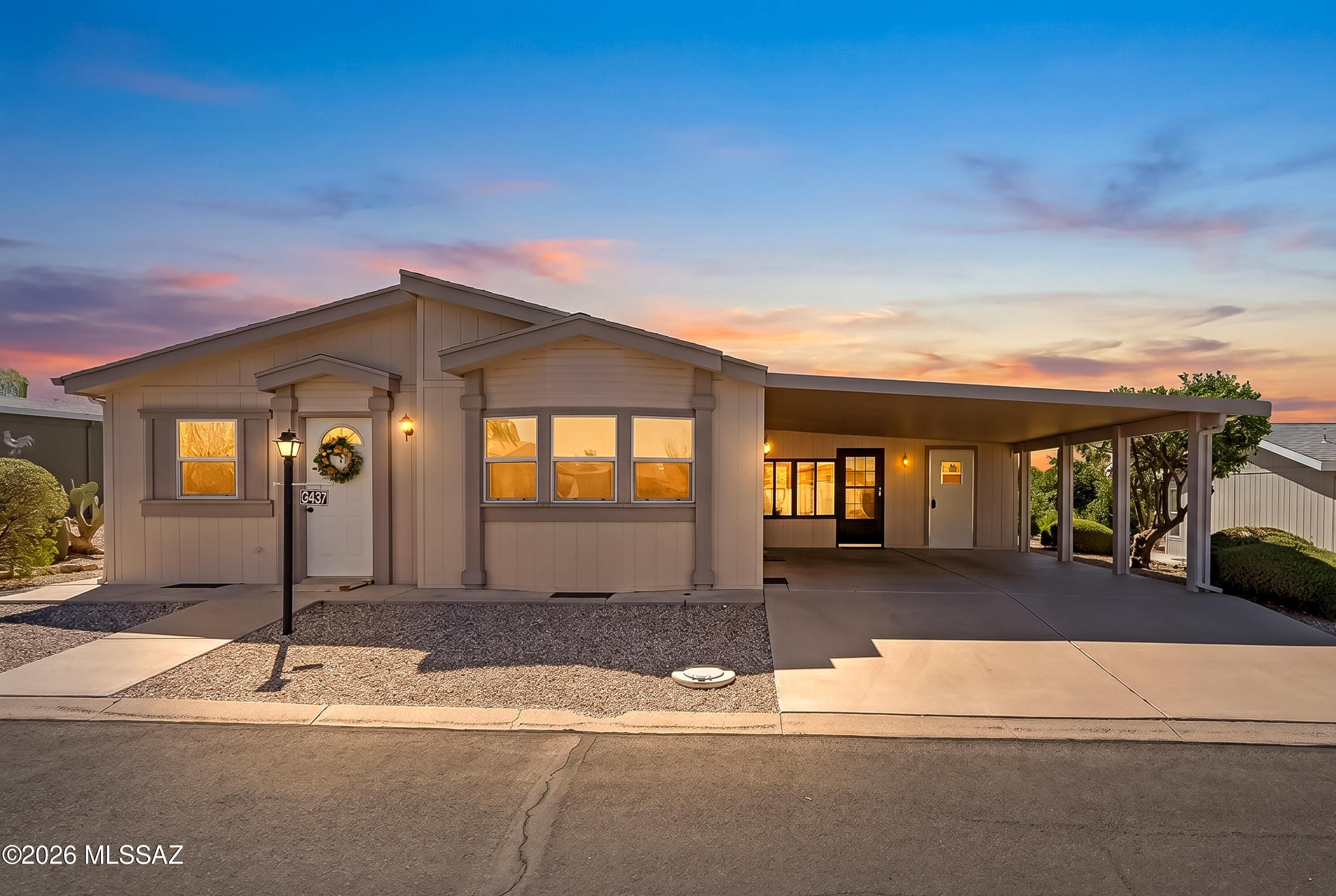 Move-in-ready Hallmark home located on a quiet street with a beautiful backyard in the desirable Copper Crest 55+ gated community. This 2-bedroom, 2-bath home features attractive laminate flooring, a bright and open living room, oak cabinetry and a dining area. Additional highlights include a spacious Arizona room, laundry room, with utility sink, and extra storage. Outside, enjoy a dual carport, mature fruit trees, and low-maintenance landscaping. Copper Crest offers an active adult lifestyle with low HOA fees and exceptional amenities, including a Jr. Olympic-sized pool and spa, clubhouse, fitness center, yoga, library, game room, crafts and quilting activities. Bocce Ball, shuffleboard, and an active hiking group.