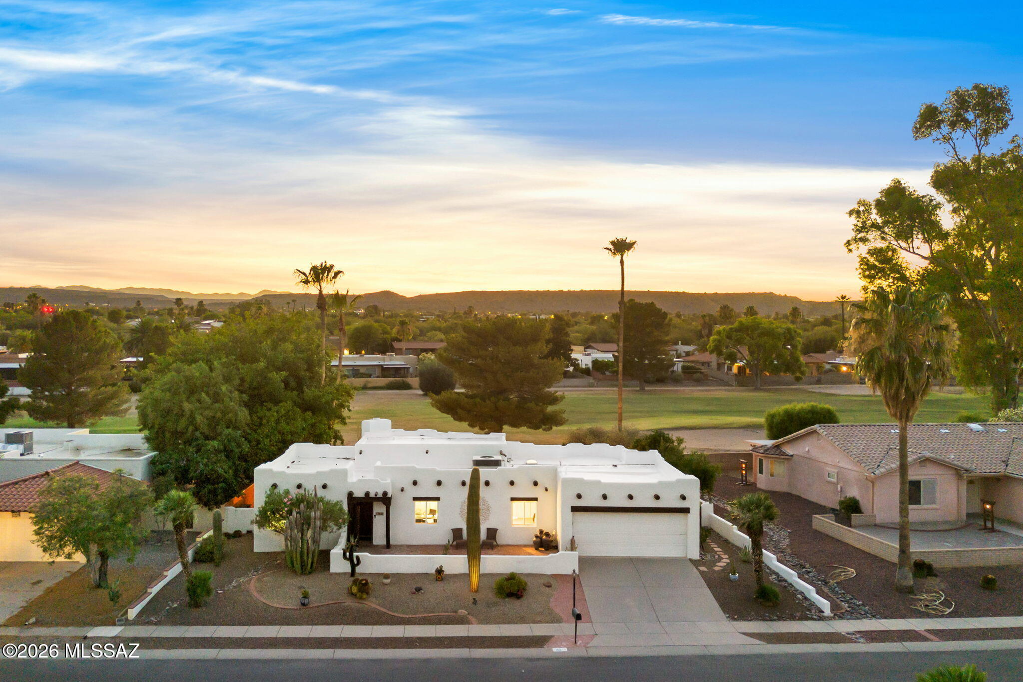 Golf Course. Pool. Mountain Views. Yes, All Three!
Welcome to one of Green Valley's most sought after addresses, right next to the Green Valley Country Club and restaurant. From the moment you arrive, this home makes a statement. A charming front courtyard greets you with gorgeous mountain views and an inviting patio -- the perfect spot for your morning coffee or an evening glass of wine as the desert sky puts on a show.
Step inside and the wow factor continues. Soaring ceilings and a fireplace anchor the open great room, and the view straight through to the pool and golf course will stop you in your tracks. This is the home you have been picturing. The kitchen opens to a sunny dining nook, keeping the great room open and uninterrupted. Three bedrooms give you flexibility -- use the third as a bedroom, home office or private den. The master suite is a genuine retreat, generous and serene, with dual vanities, a soaking tub and walk-in shower. Guests will appreciate the Murphy bed in the second bedroom, a smart touch that makes the space work beautifully whether you need a bedroom or a sitting room.

Then there is the backyard. A sparkling blue pool with waterfall, outdoor bar, smoker, fruit trees and golf course views with open space and no near neighbors -- this is Southern Arizona outdoor living at its absolute finest. Entertain, relax, or simply sit back and take in the view. There is no better place to be.

Homes with this combination of location, lifestyle and features rarely come to market. This is the one!