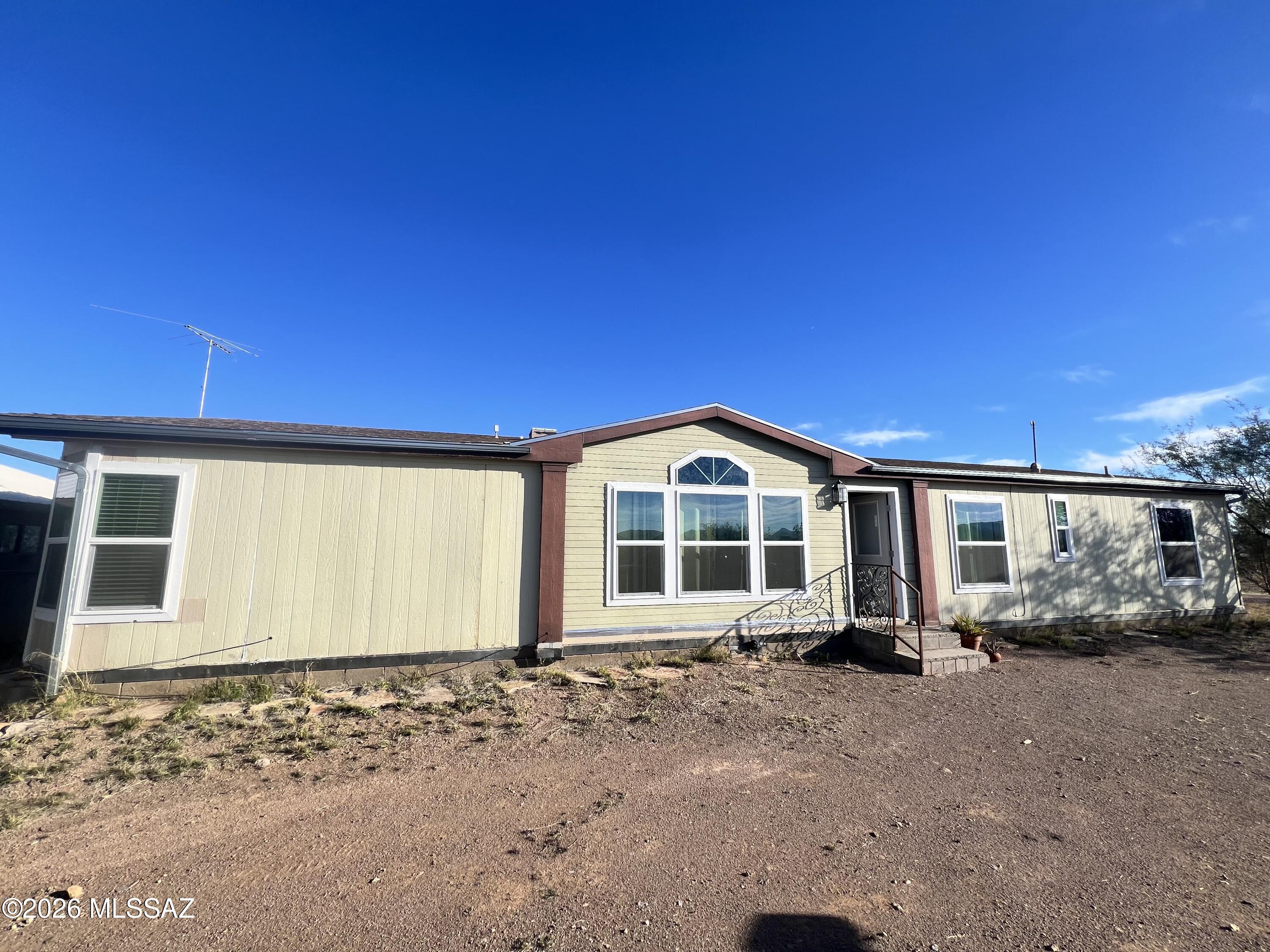 Amazing views on 9.69 ac. of fully fenced Serenity for your horses or livestock. This 1960 sq. foot double wide has been fully remodeled inside with all new Hickory cabinets in Kitchen , 2 new baths, Laminate Hickory Flooring, Ceiling Fans, & Freshly Painted. A double Stucco detached garage appx. 837 sq. foot with water, sewer, electricity, & bathroom ready to be remodeled for your Casita, Man or Lady cave or Art Studio. Newer HVAC & part of the roof is new as well. The View will speak for itself & 1/2 mile from 1,000's of acres of state land.