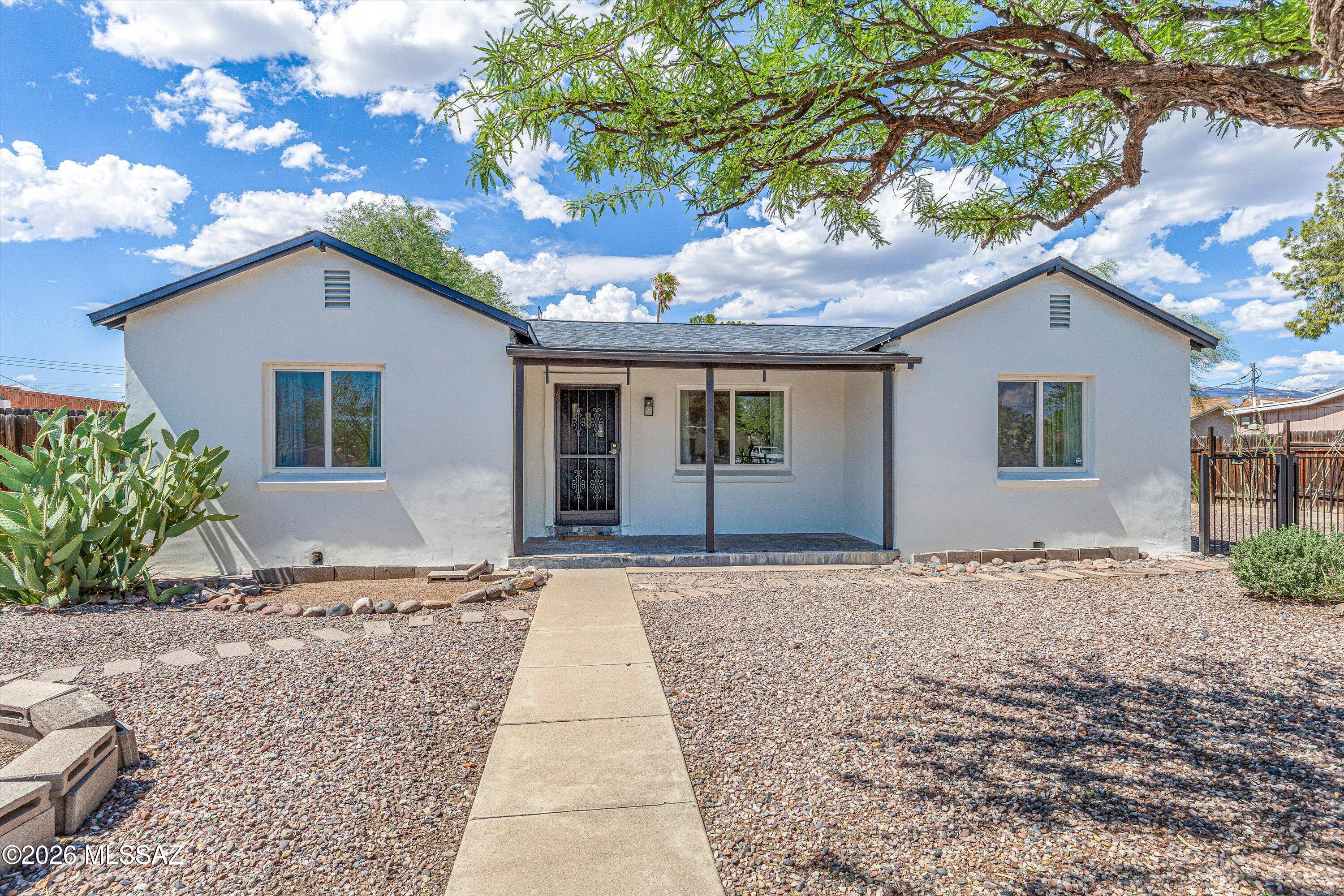 Your opportunity to own a home with a unique blend of timeless charm and modern
comfort is right here. This beautifully preserved stucco home showcases the
craftsmanship and character of the 1940s along with modern updates pleasing to
everyone. Classic vintage features include hardwood plank and tile floors, decorative
arched doorways, and glass ceiling light covers that reflect the home's history. The
updated kitchen has quartz countertops, gas cook range, and an abundance of cabinets. The extra room off of the kitchen can be used as a pantry.  Other updates include a tankless water heater, and dual pane windows. The roof is only 3 years old, all appliances less than 5 years old. With a spacious .26-acre lot, there are endless possibilities: add an accessory dwelling unit, pool, workshop, dog run, or urban garden. Use your imagination. This home is close to U of A, Banner Hospital, and everyday conveniences. Perfect
starter home or off-campus student housing. The sellers enjoyed living here, you will, too.   No site-unseen offers.  Buyers must be represented by Realtors