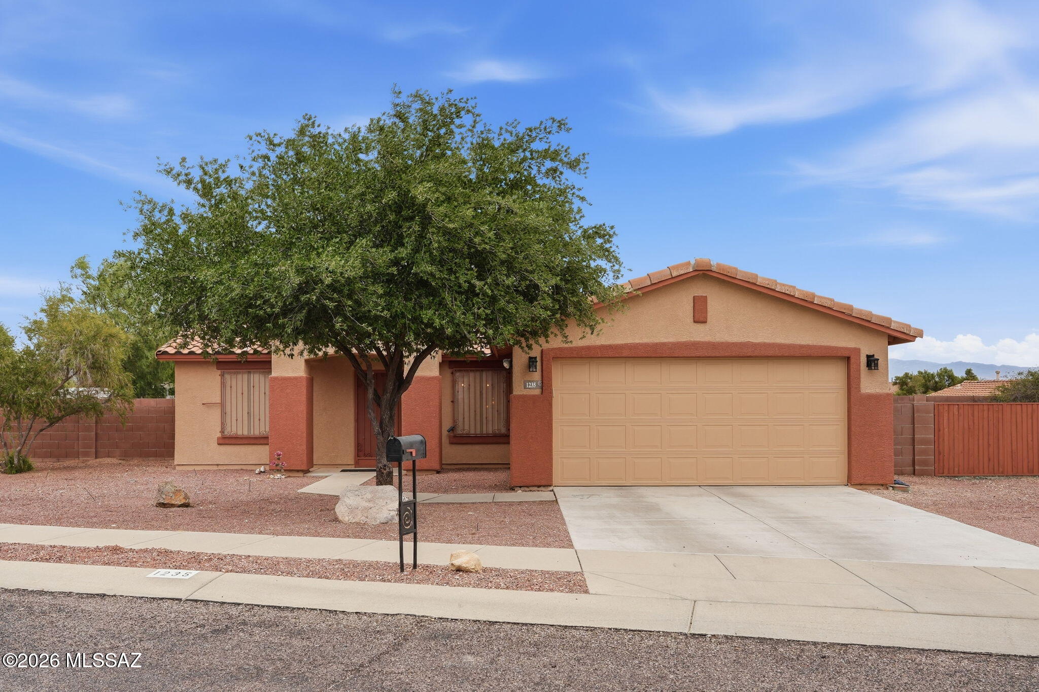This inviting home sits on a large lot with mountain views and a generous outdoor footprint. Inside, you'll find plank and ceramic tile flooring throughout--no carpet--complemented by vaulted ceilings, updated lighting, and a comfortable split floorplan. The kitchen features a gas range, breakfast bar, and stylish pendant lighting, along with newer appliances for everyday ease. Thoughtful upgrades include a newer HVAC system and exterior paint.  Outdoors, enjoy a covered patio and a huge gated side yard offering flexibility for toys, pets, or projects. A security door adds peace of mind at the entry. Conveniently located just minutes from Downtown Tucson and Pima Community College, this home blends comfort, updates, and location--ready for you to move right in!