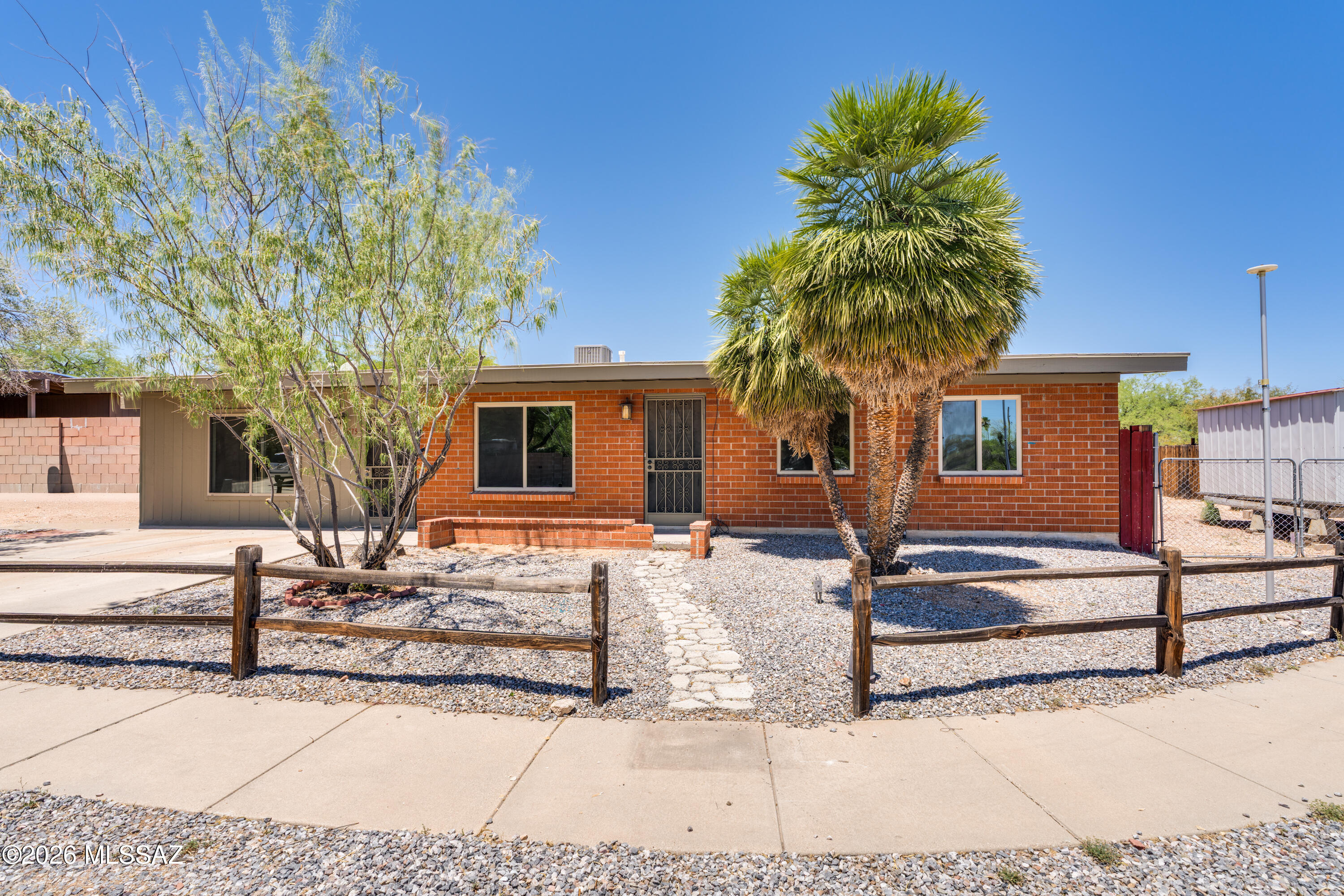 Solid brick charmer tucked on Tucson's east side with most major updates already done. Spacious 3BD/2BA plus a huge bonus room - perfect as a 4th bedroom, office, or flex space. Brand new concrete overlay flooring throughout (no carpet!), completely remodeled kitchen with new cabinetry, countertops, stainless appliances, and washer/dryer included. Refreshed bathrooms, fresh interior and exterior paint, new AC, and newer windows. The big stuff is handled! Large lot with attached storage shed plus two additional sheds. Experience the charm of a mature neighborhood with no HOA and a community of neighbors who have invested in the area for years. Backyard has room for a pool and is a blank canvas that is ready for you to make it your own! Side gate provides access to additional rear parking for extra vehicles. Truly move-in ready - this one checks every box.