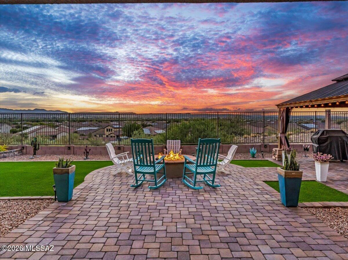 Some homes just have that feeling the moment you pull up, and this one delivers before you even walk through the door. Nestled in the gated community of Arbor at Madera Highlands, this 4 bedroom, 3 bath, 2,426 sq ft home sits on a premium elevated lot with sweeping views and no rear neighbors.

Loaded with over $93K in builder upgrades + $30K in seller upgrades. The open concept layout is everything. The kitchen speaks for itself. The primary bath feels like a spa you never have to leave. The 4-foot extended 3-car tandem garage with epoxy floors and a water softener is perfect for anyone who needs room for the toys, the tools, and everything in between.

Step outside to a built-in gazebo, gas fire pit, and finished landscaping made for Arizona evenings. Extra paver parking sits alongside the home and every detail has been thought of so you don't have to.

Newer construction living at its absolute best. No waiting, no upgrading, no compromising.