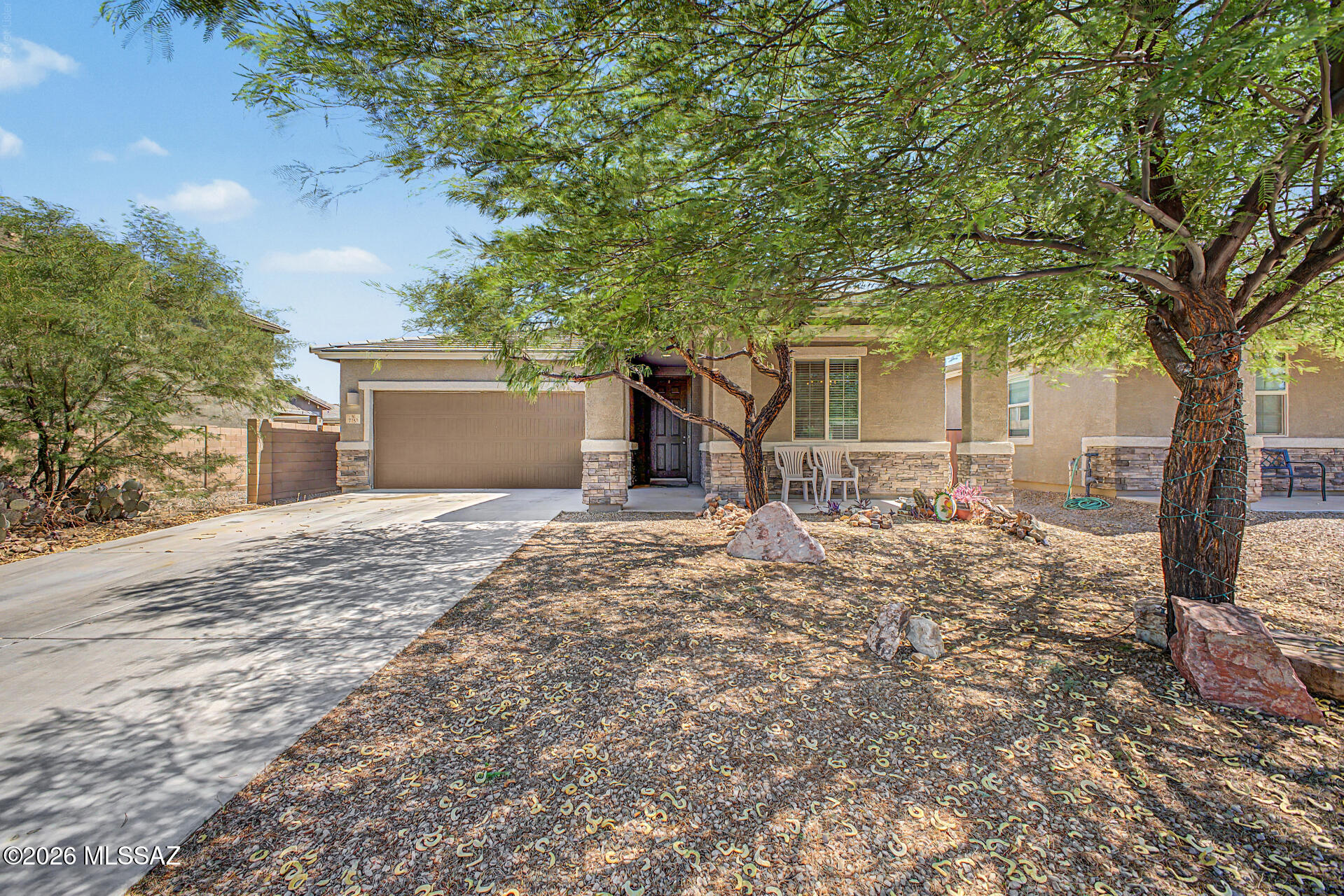 Nestled in the desirable Valhalla Estates community, this beautifully maintained 3-bedroom, 2-bath home offers an inviting blend of comfort, style, and functionality. Mature shade trees, attractive stone accents, a welcoming front sitting patio, and a 2-car garage create wonderful curb appeal. Inside, you'll find an open-concept split floor plan with soaring ceilings, abundant natural light, a neutral color palette, and attractive wood-look flooring throughout the main living areas. The spacious kitchen is designed for everyday living and entertaining, featuring granite countertops, rich wood cabinetry, recessed lighting, built-in appliances, a pantry, and a large island with breakfast bar seating. The private primary suite offers plush carpeting, a walk-in closet, and an ensuite bathroom. Step outside to a generously sized backyard complete with a covered patio, extended patio area, mature desert landscaping, and ample room to create the outdoor retreat you've always envisioned. Don't miss out on this fantastic opportunity!