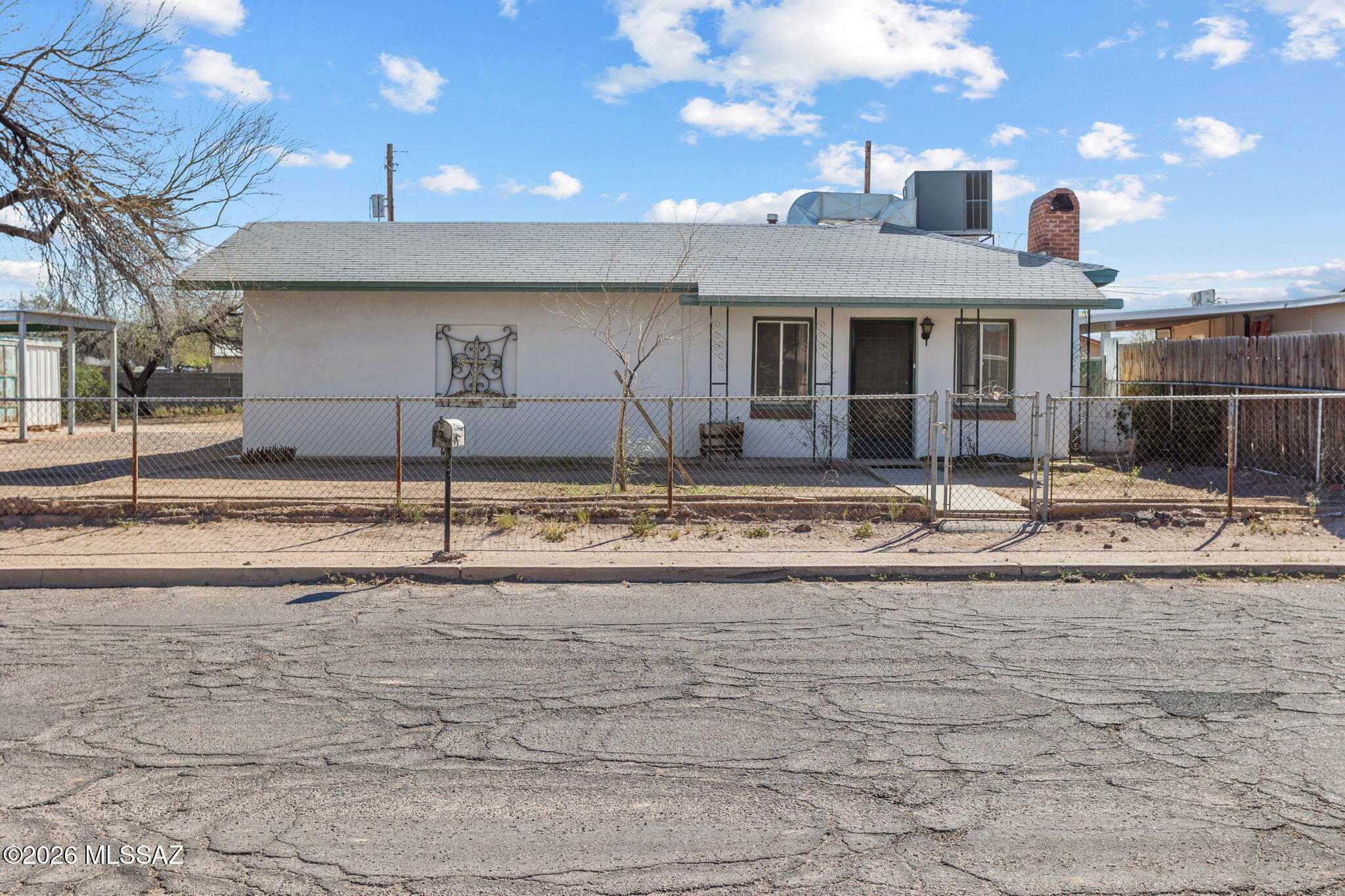 Versatile home offering 3 bedrooms or 2 bedrooms plus an office. Tandem third bedroom includes a large walk-in closet. Situated on a spacious lot, this property includes the adjacent parcel (719 W. President St, Tucson, AZ 85714; Parcel #120-02-0920). Adjacent lot features a metal carport and 150 sq ft storage building. Combined lot size approx. 0.38 acres, providing ample outdoor space and potential investment opportunities. Interior features include walk-in closets, remodeled walk-in shower, and new water heater. Car enthusiasts, hobbyists, or those needing extra workspace will appreciate the impressive 30' x 30' garage with 12-foot ceiling.