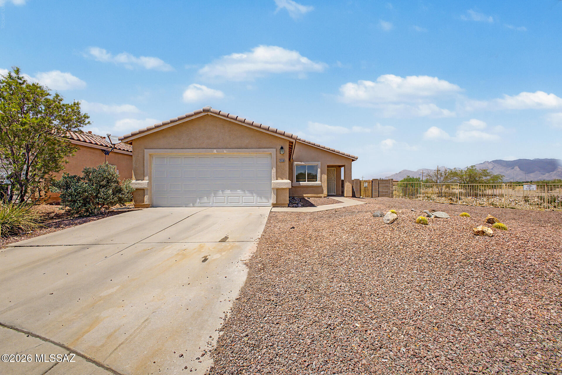 Welcome home to this charming corner lot residence with a 2 car garage and beautiful Santa Catalina Mountain views in the lovely Ironwood neighborhood. Offering 1,176 square feet of comfortable living space, this inviting home features 3 bedrooms, 2 bathrooms, soaring vaulted ceilings, and a bright, open layout designed for everyday living. The well-appointed kitchen comes complete with all appliances, including a gas range, microwave, dishwasher, and side-by-side refrigerator, making move-in easy. The spacious primary suite provides a private en suite bathroom for added comfort and convenience. Step outside to a generous backyard that backs to open space, where you can relax beneath the covered patio while taking in the picturesque mountain views. Conveniently located with easy access to Interstate 10, this home is just minutes from schools, parks, shopping, dining, and a variety of recreation opportunities. This is a wonderful opportunity to enjoy comfortable living in a fantastic location.