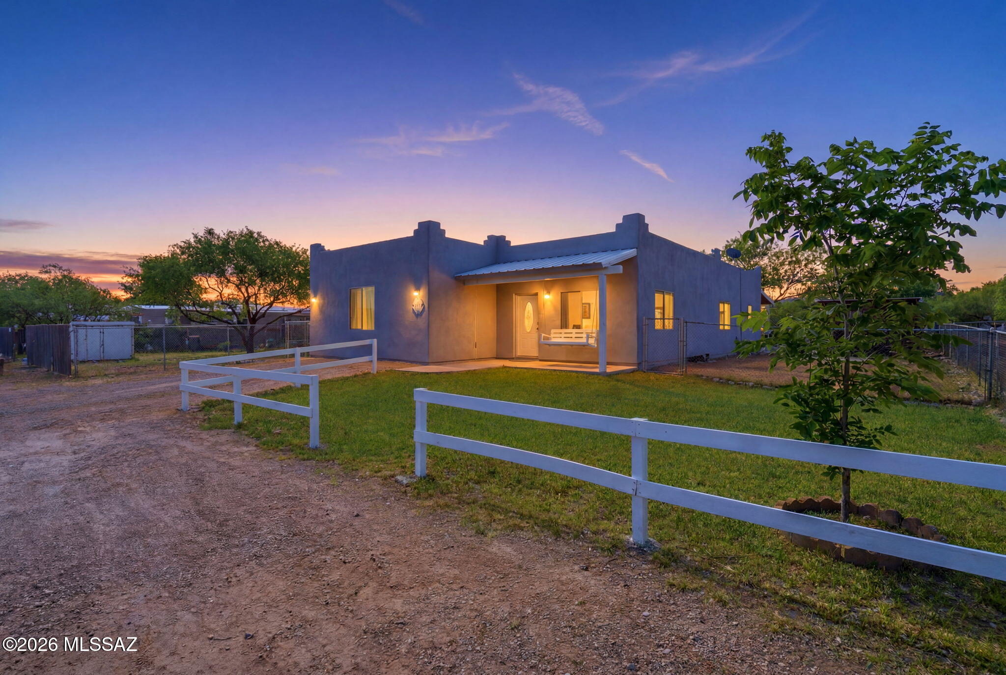 This beautifully updated Spanish-style property offers the perfect blend of comfort, charm, and peaceful living just outside the city. Ideal for first-time buyers looking for space and privacy, this home features fresh interior paint and exterior stucco, creating a clean and welcoming feel from the moment you arrive. Enjoy quiet Arizona evenings on the inviting front porch swing, entertain guests at the outdoor bar, and appreciate the low-maintenance grass. Inside, the massive bonus room provides endless possibilities for a game room, second living area, or home office, while the huge laundry room offers exceptional storage and functionality. Additional upgrades include a new water heater, making this home move-in ready and designed for relaxed country living.