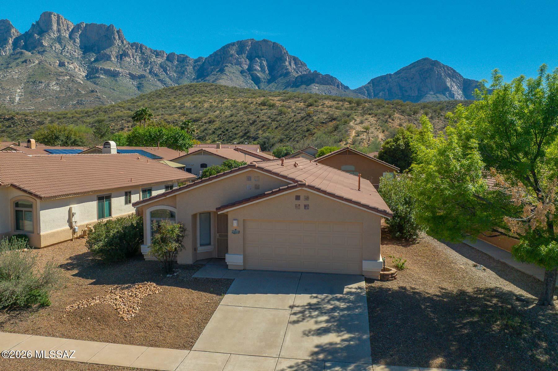 Charming updated home nestled in the Catalina Mountains -easy walk to trails and close to shopping, schools and loop trails.
3BR/2BR with a two car garage. Ceramic tile through-out, carpet in bedrooms. Kitchen has newer granite and appliances which include refrigerator, washer and dryer. Newly landscaped back yard with turf and sitting areas to view the Catalinas. Owner/Agent