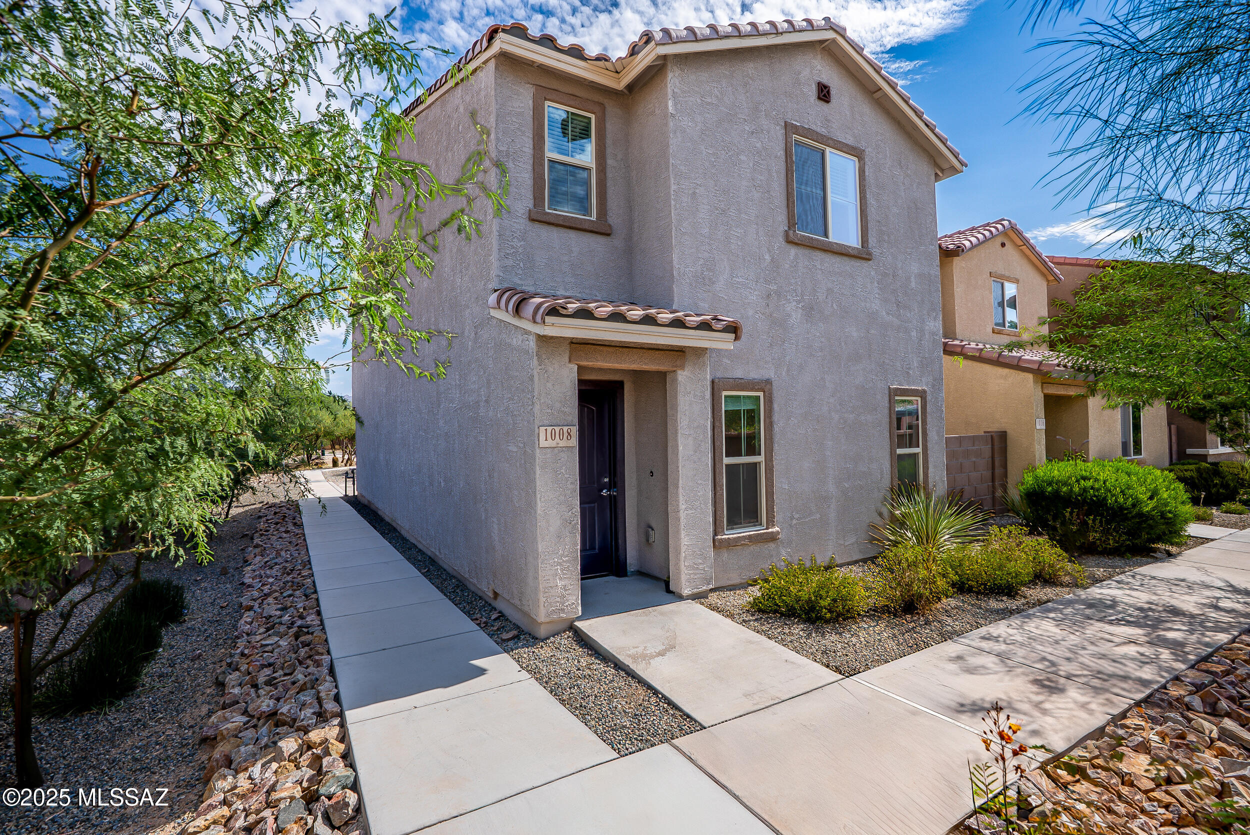 Central Tucson retreat in the desirable Mountain Enclave subdivision. Built in 2022, this modern 3-bedroom, 2.5-bathroom home offers contemporary finishes, thoughtful design, and a rare corner lot location. The open-concept Great Room flows into a sleek kitchen featuring espresso cabinets, upgraded quartz countertops, stainless steel appliances, and a gas range--ideal for cooking and entertaining. A convenient half bath is located on the main floor. Upstairs, the light-filled primary suite includes a spacious ensuite bathroom with a double vanity and an expanded walk-in shower. Two additional bedrooms, a full bathroom, and a generously sized laundry room provide comfort and practicality. Enjoy upgraded, hand-laid pavers throughout the low-maintenance exterior. Fresh off a successful short- term rental period, this pristine contemporary gem returns to the market at an exceptional value!
