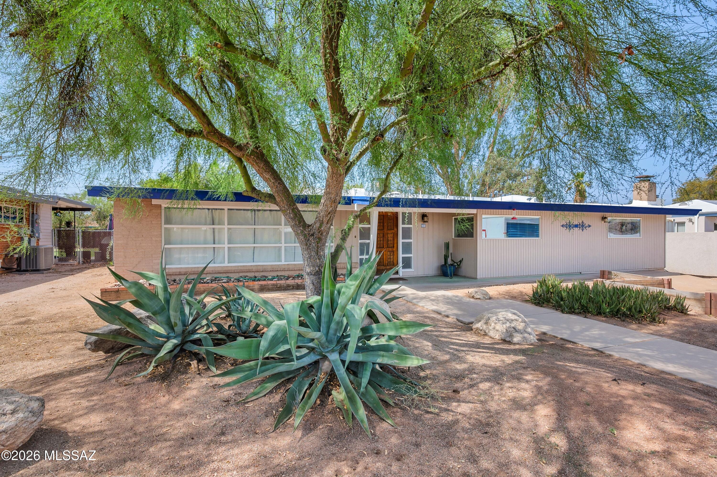 Perfectly positioned in the heart of Tucson's beloved Poet's Corner, this thoughtfully renovated residence offers the ideal blend of timeless character, modern updates, and exceptional livability. With three bedrooms, two beautifully remodeled bathrooms, and a versatile flex room ideal as a home office, library, or creative studio, the home is designed to adapt effortlessly to today's lifestyle. Inside, generous living spaces create an inviting atmosphere, featuring a spacious living room, dining area, and an expansive family room anchored by a welcoming fireplace. The beautifully remodeled kitchen serves as the heart of the home, complete with an eat-in island, quality finishes, and an open flow that makes both everyday living and entertaining effortless. Newer tile flooring (continued) throughout the main living areas enhances both style and durability, while abundant natural light fills the home through many updated windows. The spacious primary suite offers a true retreat, complete with an oversized walk-in closet and a luxurious ensuite bath featuring a separate soaking tub and walk-in shower. Equally impressive, the oversized backyard presents endless possibilities. Mature shade trees and a covered patio provide an inviting setting for relaxing or entertaining, while the fenced swimming pool creates the perfect place to enjoy Tucson's year-round sunshine. With ample additional yard space, there's still room to create the outdoor oasis you've always envisioned. Extensively updated for peace of mind, the home features an HVAC system, roof, and water heater all less than ten years old. Additional significant improvements include a Perma-Liner sewer liner extending from the home to the main sewer line, along with added cleanouts, valuable infrastructure upgrades rarely found in homes of this era. Situated in one of central Tucson's most desirable neighborhoods, Poet's Corner is known for its mature landscaping, charming streets, and exceptional convenience. Enjoy easy access to the University of Arizona, Banner University Medical Center, Reid Park, The Loop, downtown Tucson, and the vibrant Campbell Avenue corridor, with its celebrated restaurants, boutiques, cafés, and everyday amenities just minutes away. This is a rare opportunity to own a beautifully updated home in one of Tucson's most enduring and sought-after neighborhoods.