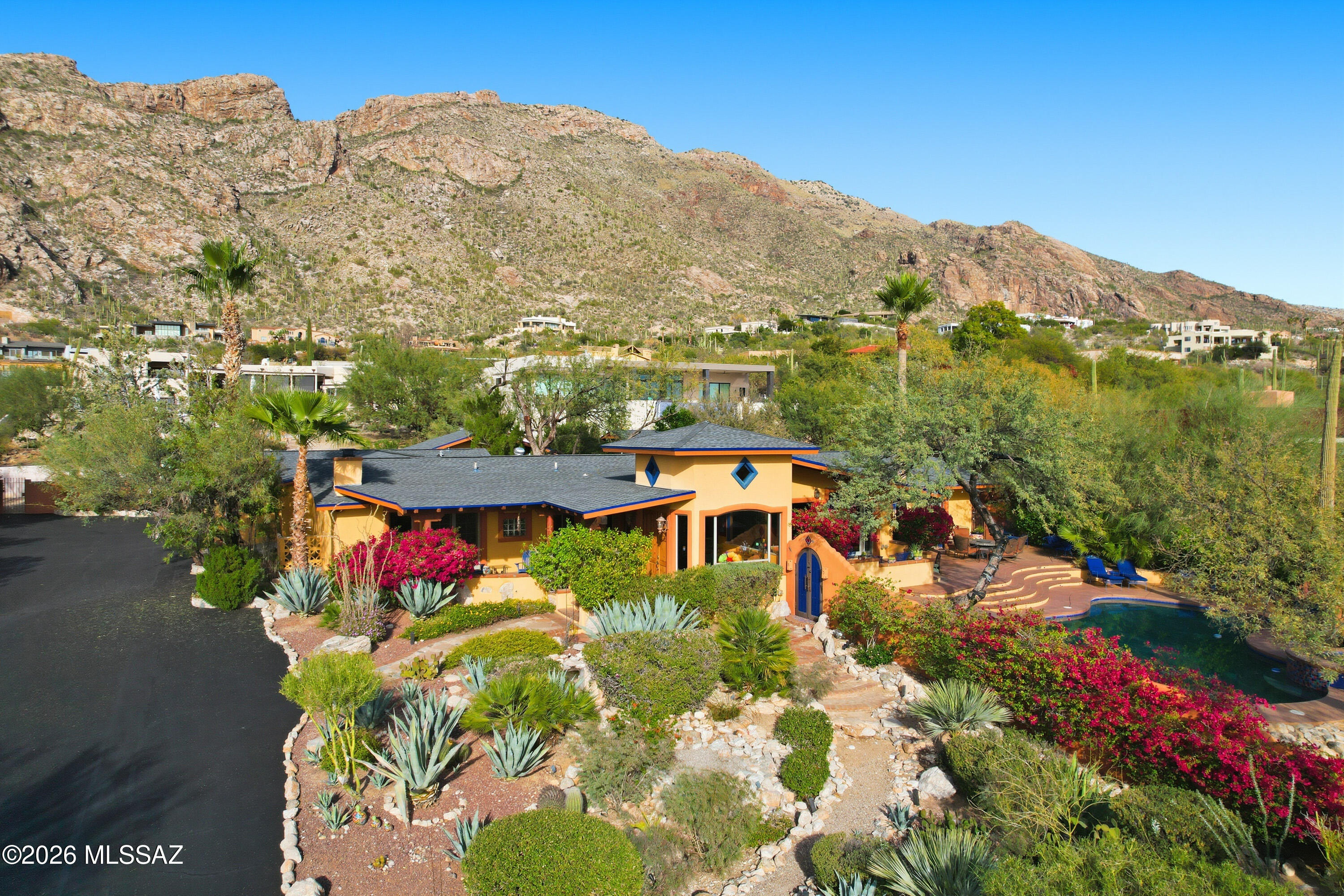 Experience quintessential Southwest living in this exceptional Tucson estate, offering a stunning blend of comfort & character. 5-bedroom, 5-bath main house features a desirable split floor plan, authentic Saltillo tile, & freshly painted interior. Striking 2-sided fireplace warms both family & living areas.  Primary suite is secluded w/a cozy kiva fireplace & private patio. Stylish, functional kitchen opens to dining areas which flow easily to the outdoor covered patios. Resort-style yards create a true desert oasis showcasing mature vegetation, featuring a luxurious pool & spa w/an endless view backdrop, separate casita, studio w/dry sauna & relaxing waterfalls. Roofs replaced in 11/25. Conveniently located at the top of Swan for A+ views. Near schools, shopping, dining, trails & more!