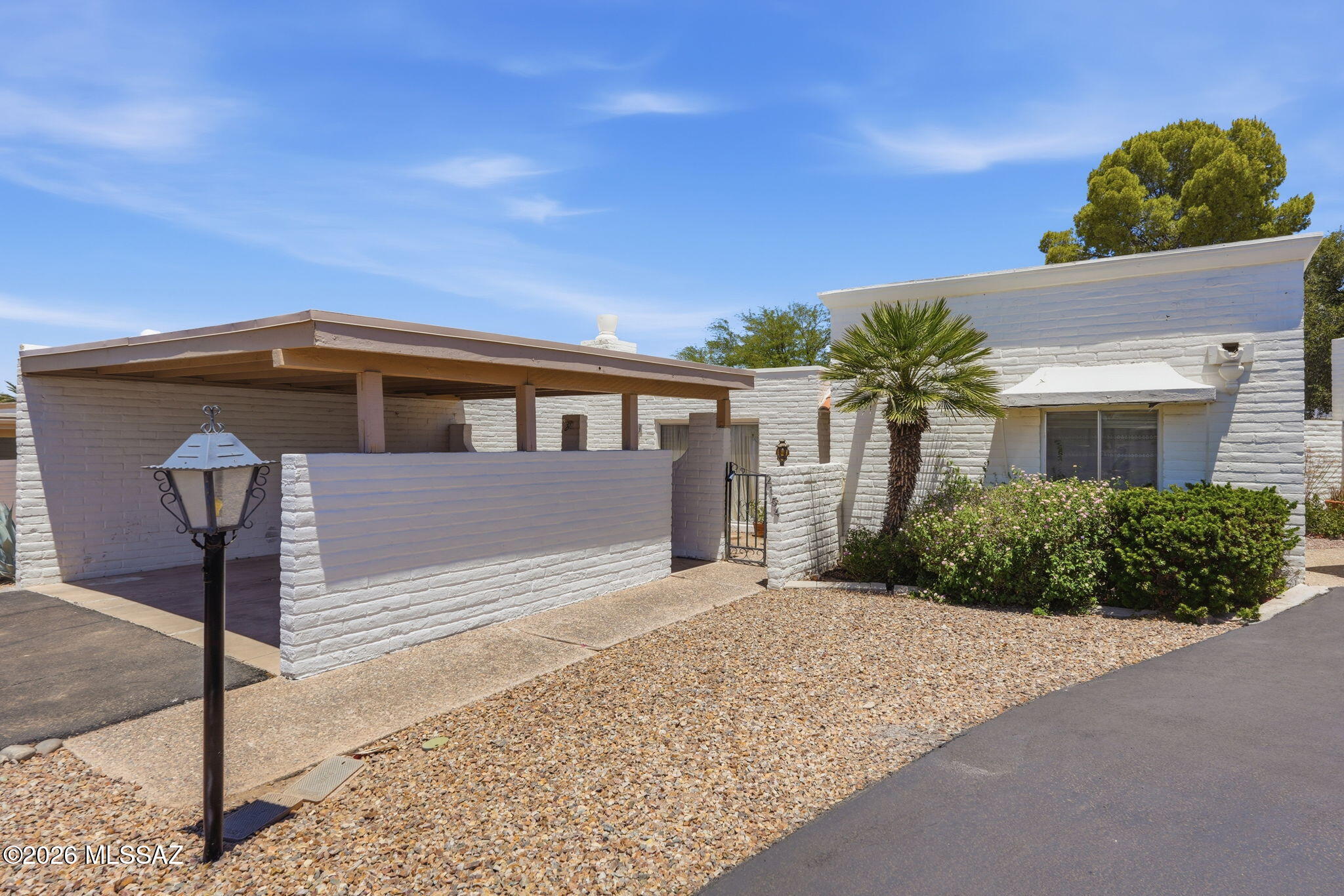 This delightful 2-bed, 2-bath townhouse with OWNED solar on an oversized lot in NE Tucson is ready for you. The spacious living room is anchored by a cozy beehive fireplace. The wide hallway with safety railing & split-bedroom layout offer privacy, peace of mind & flow. The kitchen features light wood cabinetry, a closet pantry with saguaro rib doors & a breakfast nook. The primary suite boasts TWO walk-in closets. Skylights are smartly positioned throughout the home to boost natural light. Outside, enjoy mountain views from the backyard, a private front courtyard & extra outdoor space w/ 2 storage sheds (1 w/ power and endless possibilities for storage or hang out space). Classic slump block construction & low-maintenance landscaping blends character, serenity & Southwest soul.