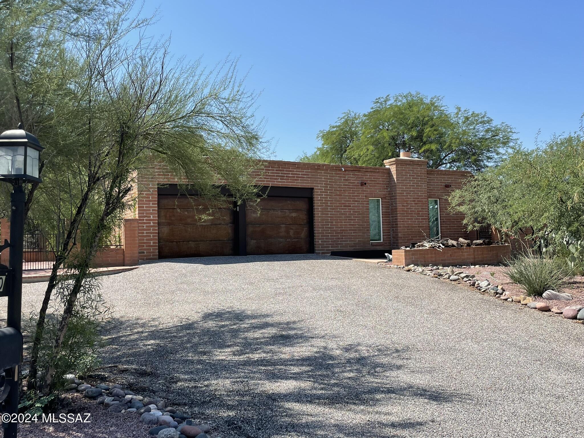This home has character! Perched upon a .75 acre lot, the indoor and outdoor spaces are conducive to desert living. Lots of options when it comes to living areas, design your perfect space. Enormous open kitchen, includes two sinks, two dishwashers, separate prep and cabinet storage areas. Step down into the front living space with built in cabinetry, or wander to the back living area which includes a wet bar. Both bathrooms have been updated and upgraded with copper accents. The Owners Suite bath is a spa like paradise! Speaking of the owners suite, this spacious room includes a walk in closet, and door out to the back. Generous use of hardscape to sit and enjoy the beauty of the desert. Tranquil gated front area with many desert plants. Tenant occupied until 7/31.