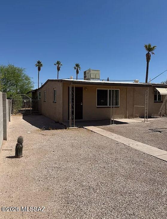 Freshly painted 3BR/1BA home in a convenient central Tucson location within walking distance to grocery stores, bus lines, schools, and everyday shopping. This spacious home offers tile flooring throughout with no carpet, making cleaning and maintenance easy. Stay comfortable year-round with central A/C. The functional floor plan includes generous living spaces and a practical kitchen setup ready for everyday living. Outside, enjoy both a large front yard and backyard with plenty of room to relax or entertain. The property also includes a one-car carport and additional off-street parking. Conveniently located near major roadways for easy access around Tucson. Small dogs welcome. Call today to schedule a showing!