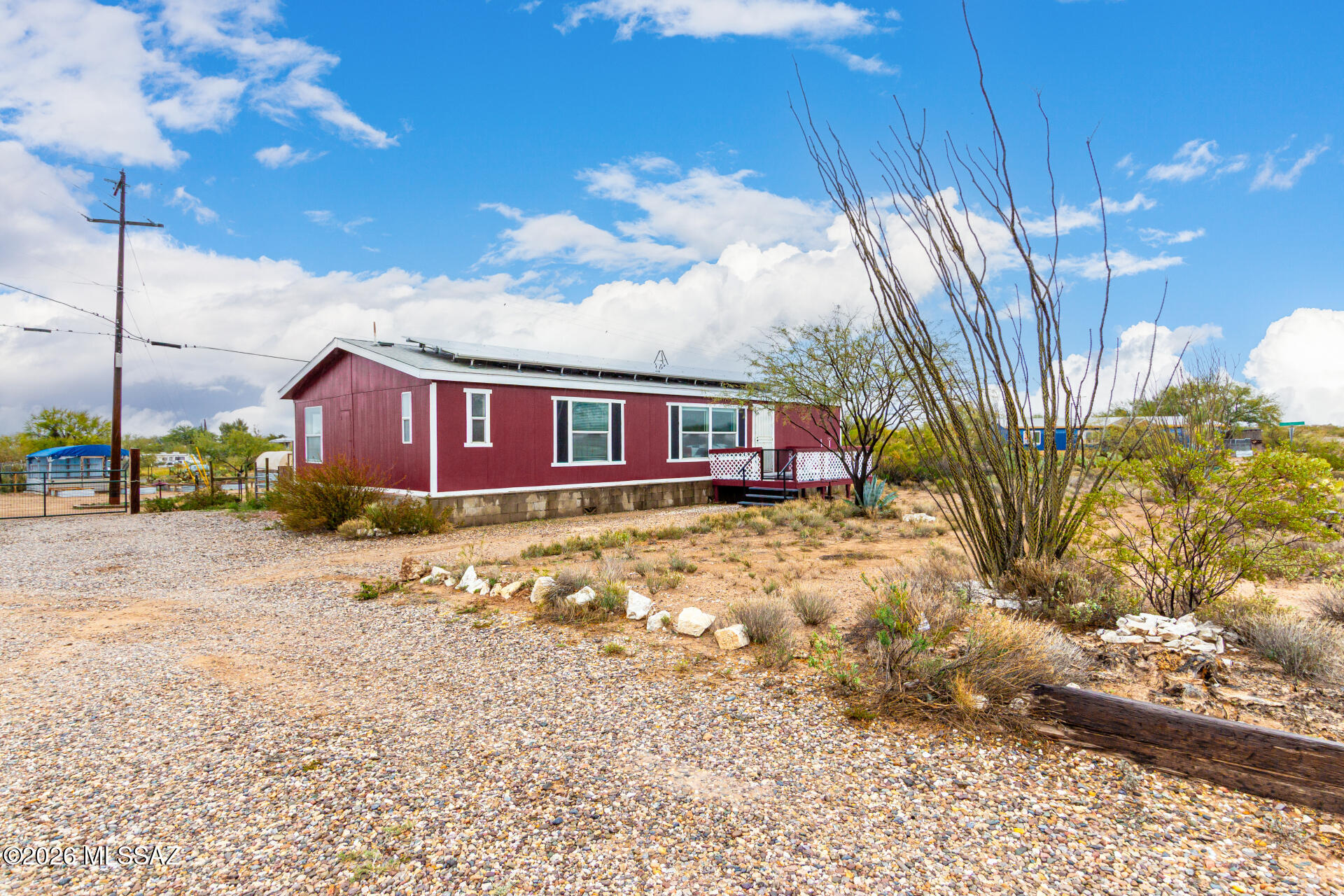 Dreaming of a little more space? This 1-acre property gives you room to spread out, start a garden, raise chickens, build the greenhouse you've been pinning, or finally have space for all your toys.The welcoming front porch is the perfect place to enjoy your morning coffee while taking in the Arizona sunshine and mountain views. Inside, the open floor plan feels bright and inviting with vaulted ceilings, tons of natural light, wood-look flooring, and a neutral color palette that's ready for your personal style. The kitchen is truly the heart of the home, featuring honey oak cabinets, a center island, breakfast bar, and a cozy breakfast nook for slow mornings or casual meals. The spacious primary suite offers a private bath with dual sinks and a soaking tub-the perfect place to unwind after a long day. Step outside and imagine the possibilities. The expansive backyard is ready for raised garden beds, greenhouses, animals, RV parking, or simply enjoying wide-open space under Arizona skies. And with owned solar, you'll enjoy the added bonus of lower energy costs while living the homestead lifestyle.