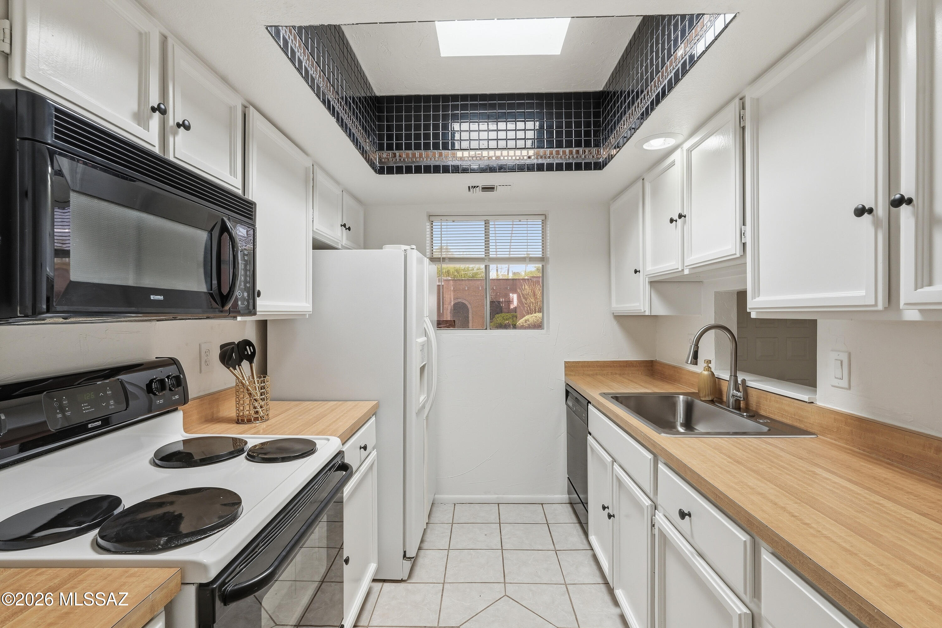Rarely do you find a 3-bedroom in the Star Pass area with this much Tucson personality at a price that doesn't cause sticker shock. Freshly painted with NO carpet anywhere, this move-in ready home blends Southwest charm with easy living. You will be surprised how much interior living space is packed into1187 sq feet . Enjoy two private patios -- one covered with a tranquil fountain and another featuring a custom-built grill area with authentic Tucson flair. Inside, skylit bright spaces, French doors, and clean finishes create an airy vibe that feels calm the second you walk in. Two parking spaces are right outside your door, including one covered spot. Community pool, serene surroundings, and easy access to trails, bike paths, downtown, U of A, and the Westside lifestyle make this one stand out fast. Maybe this one really was meant to find you.