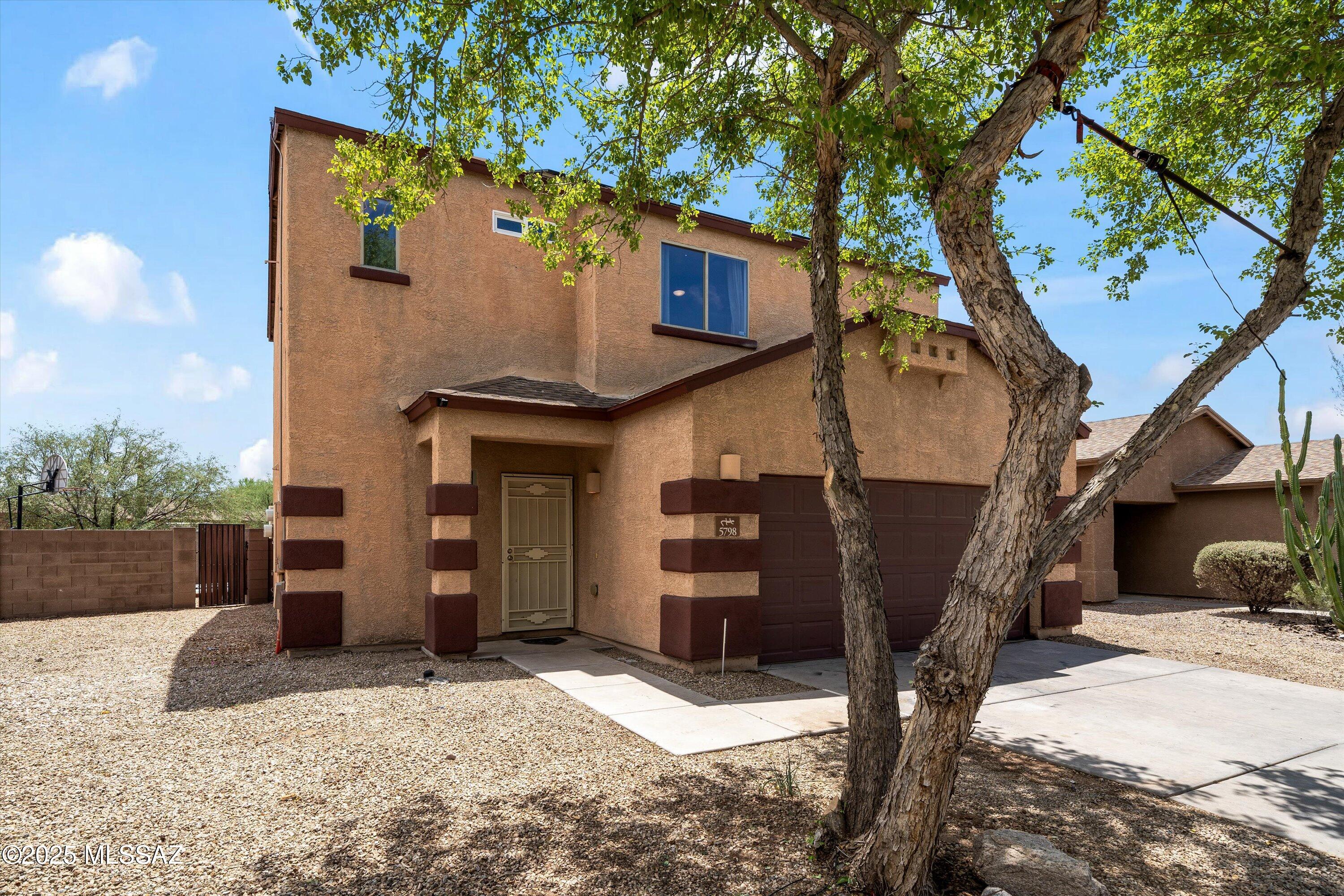 Seller will accept or counter offers between $288,999 and $308,999 dollars. Welcome to 5798 E Camino Nuestras Casas, two-story home in the heart of Corazón Del Pueblo. Featuring 4 bedrooms, 2 full bathrooms and 1 half bathroom. Step inside to a light-filled open floor plan featuring ceramic tile throughout the main level and freshly cleaned carpet upstairs. The spacious living and dining area flows seamlessly into a modern kitchen. What truly sets this home apart is the incredible backyard setup: enjoy a fully fenced brick wall yard with no rear neighbors, covered patio, and low-maintenance landscaping with pavers and artificial grass- ideal for relaxing evenings, pets, or weekend BBQs with family!