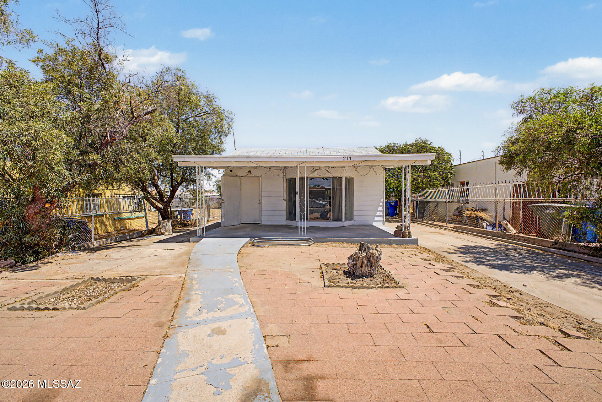 Discover this 2-bedroom property with convenient access to the I-19 and I-10 freeways, with restaurants, schools, parks, medical centers, and entertainment just moments away! This fully fenced property features a spacious front patio, ample parking, and a detached garage that works as a workshop. The interior has a bright living room and wood-look flooring. The eat-in kitchen offers wood cabinetry, a gas stove, and a dishwasher. The primary bedroom, tucked at the back of the home, boasts its own bathroom, closet, and laundry room, while the 2nd bedroom shares a jack and jill bathroom to the living area.  The backyard is a blank canvas with room for a pool to be a desert oasis with endless potential.