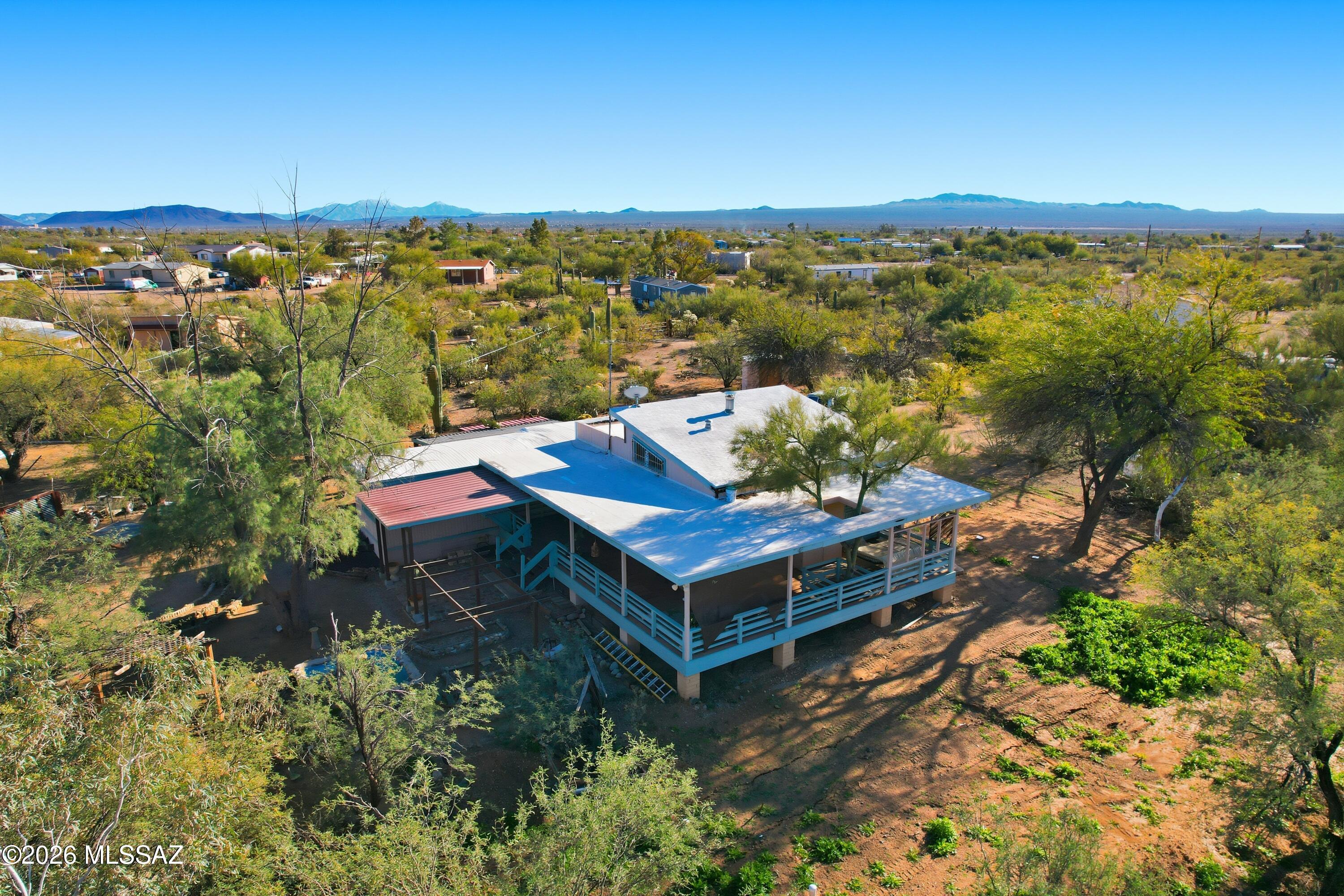 Escape to your own private country haven on a secluded, fully fenced and gated one-acre desert retreat--ideal for those seeking a farmhouse-inspired lifestyle with room to grow, create, and connect with nature. This property is thoughtfully equipped for hands-on country living, including a greenhouse, solar room, chicken coop, raised garden beds, workshop/garage, firepit, and a soothing water feature. 
A private well provides high-quality water, supporting both daily living and your sustainable lifestyle goals. Ample space for RV parking and additional vehicles.
A newly installed septic system adds peace of mind. Located just minutes from Saguaro National Monument, you'll enjoy easy access to hiking, horseback riding and endless outdoor adventures.  At the heart of the property is a charming studio featuring vaulted ceilings, clerestory windows, a loft bedroom and bath, and abundant natural light, a perfect creative space, guest retreat, or foundation for future expansion. Designed with indoor-outdoor living in mind, multiple shaded decks invite outdoor dining, quiet relaxation, and unforgettable desert sunsets and stargazing. Blending privacy, functionality, and tranquility, this one-of-a-kind property offers an exceptional opportunity for families, artists, nature lovers, and anyone seeking a serene desert escape with limitless potential.
SHOWN BY APPOINTMENT ONLY.