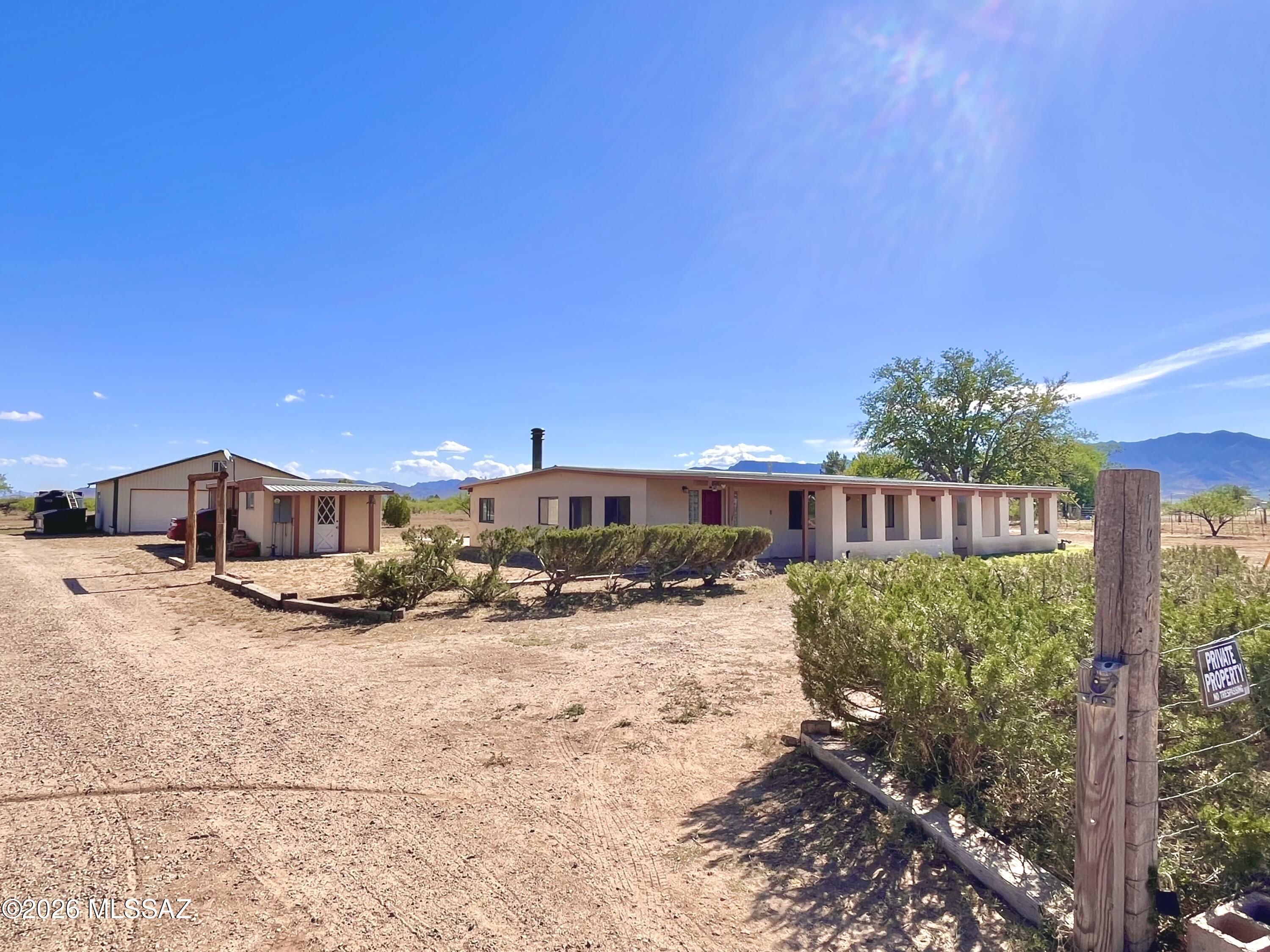 New well and pump!  

Come and see this country home on 2.67 acres just 15 miles from I-10 in Willcox!  You get so much for a great price!  Solid home, SPACE/LAND, and a large shop!

This 3-bedroom, 2-bath home offers multiple separate living areas, with potential to open up the layout into a more modern open-concept design if desired.  An Arizona room on the South end of the home provides additional flexible space to enjoy year-round! The main living area features a closed-off chimney, offering the option to install a wood-burning stove.

There is a long front porch with beautiful mountain views, and a fenced in back patio area along side a mature mulberry tree. There are several outbuilding that provide great flexibility--currently for storage but could be transformed into a home office, workshop, or hobby room.

The property also features a spacious shop in the back with both a double and single garage door, plus plenty of interior room and additional attic storage.

All buildings feature durable metal roofs, and the property is equipped with a brand new well and pump, along with a water heater just 3 years old, offering added value and peace of mind.