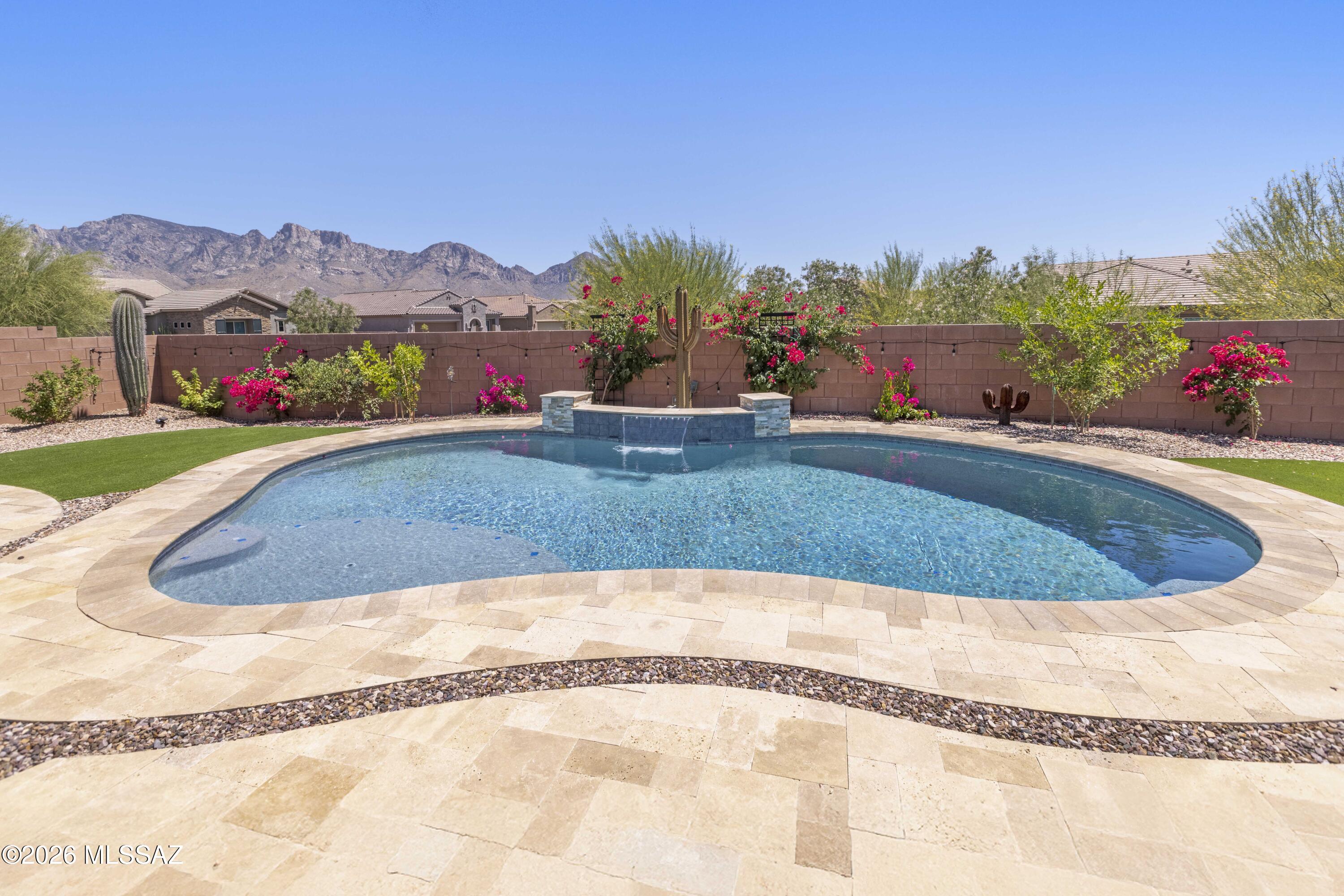 Exquisite Catalina Mtn Views-Upgraded 2458 sq ft home-perfectly positioned on an oversized CORNER lot approaching 10,000 sq. ft-Stunning 2020-built Vicenza plan with 10' ceilings, 8' doors and an extended depth 2 car garage.  In the highly sought-after Valley Vista community in Rancho Vistoso. Featuring 3 bedrooms, a den, and 2.5 baths, the home showcases a paver driveway and gated courtyard leading to a custom wrought-iron entry door.  The truly gourmet kitchen has quartz countertops, a gas cooktop, double ovens, walk-in pantry, roll out shelves, an oversized island, & LG French-door refrigerator. The open-concept great room is enhanced by a striking shiplap feature wall, mantle, and elegant electric fireplace. Designer upgrades include wood-look tile flooring throughout, and 5" baseboards, French doors at the den, custom owner's closet built-ins, barn door, and a luxurious spa-inspired bath. The resort-style backyard is the ultimate retreat with a sparkling pool featuring waterfall and LED lighting, mature clementine and pomegranate trees, no rear neighbor, and sweeping mountain vistas. Ideally located steps from hiking trails, paved multi-use paths, and miles of The Loop, with shopping, dining, and medical facilities just minutes away. One seller is a licensed real estate agent in AZ.