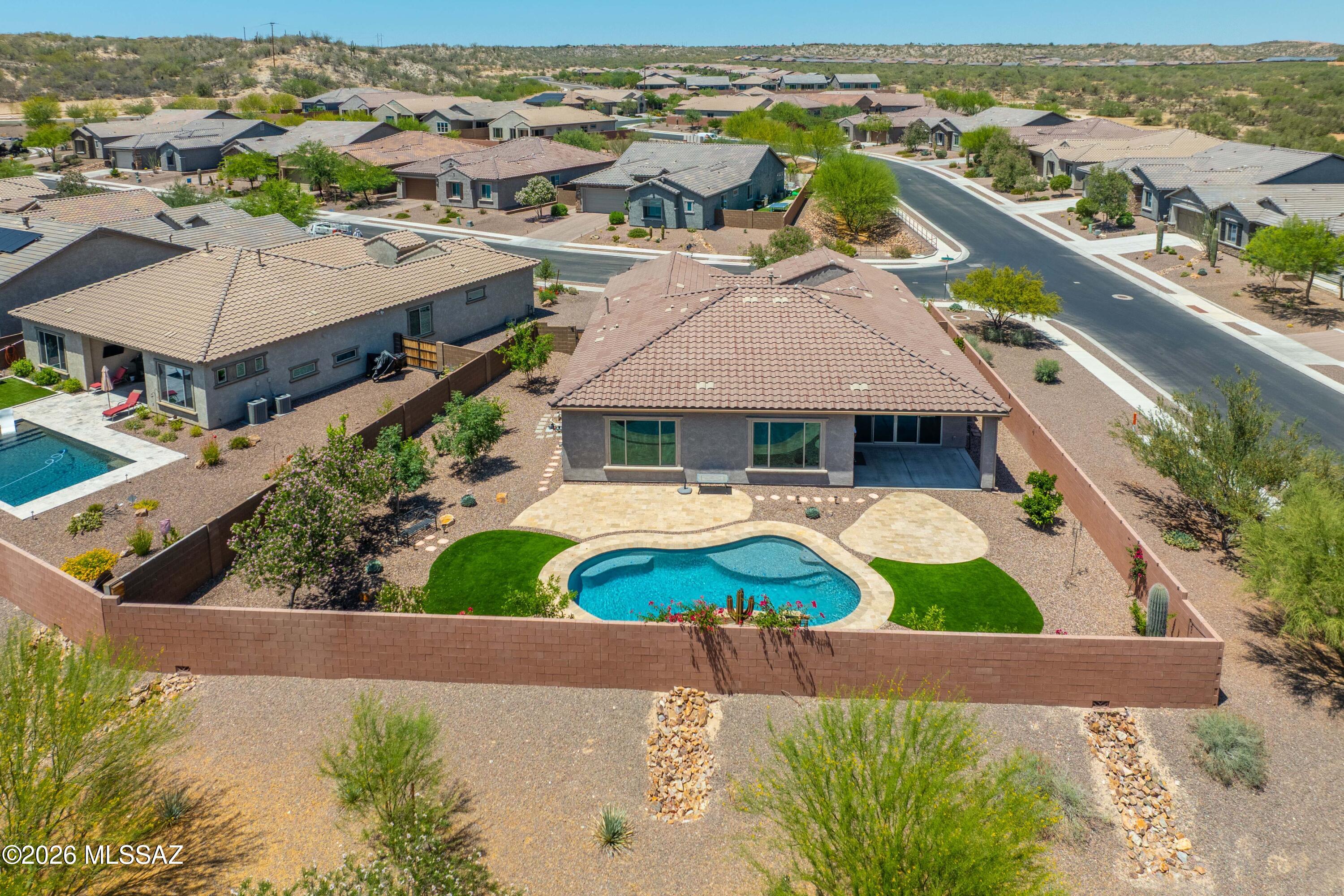 Exquisite Catalina Mtn Views and Sparkling Pool!This 2458 sq ft home is perfectly positioned on an oversized CORNER lot shy of 10,000 sq. ft-Stunning 2020-Pulte Homes Vicenza plan located in Valley Vista-with HOA Dues only $36 month! Steps away from the multi-use path (the LOOP), parks, Oro Valley Market Place and Hospital. Home has 3 Bds, Den +2.5 baths. 10' ceilings, 8' doors and an extended depth 2 car garage, paver driveway and gated courtyard leading to a custom wrought-iron entry door. The truly gourmet kitchen has quartz countertops, a gas cooktop, double ovens, walk-in pantry, roll out shelves, an oversized island, & LG French-door refrigerator. The open-concept great room is enhanced an elegant fireplace. You'll also find tile flooring everywhere except the close The resort-style backyard is the ultimate retreat with a sparkling pool featuring waterfall and LED lighting, mature clementine and pomegranate trees, no rear neighbor, and sweeping mountain vistas. One seller is a licensed real estate agent in AZ.